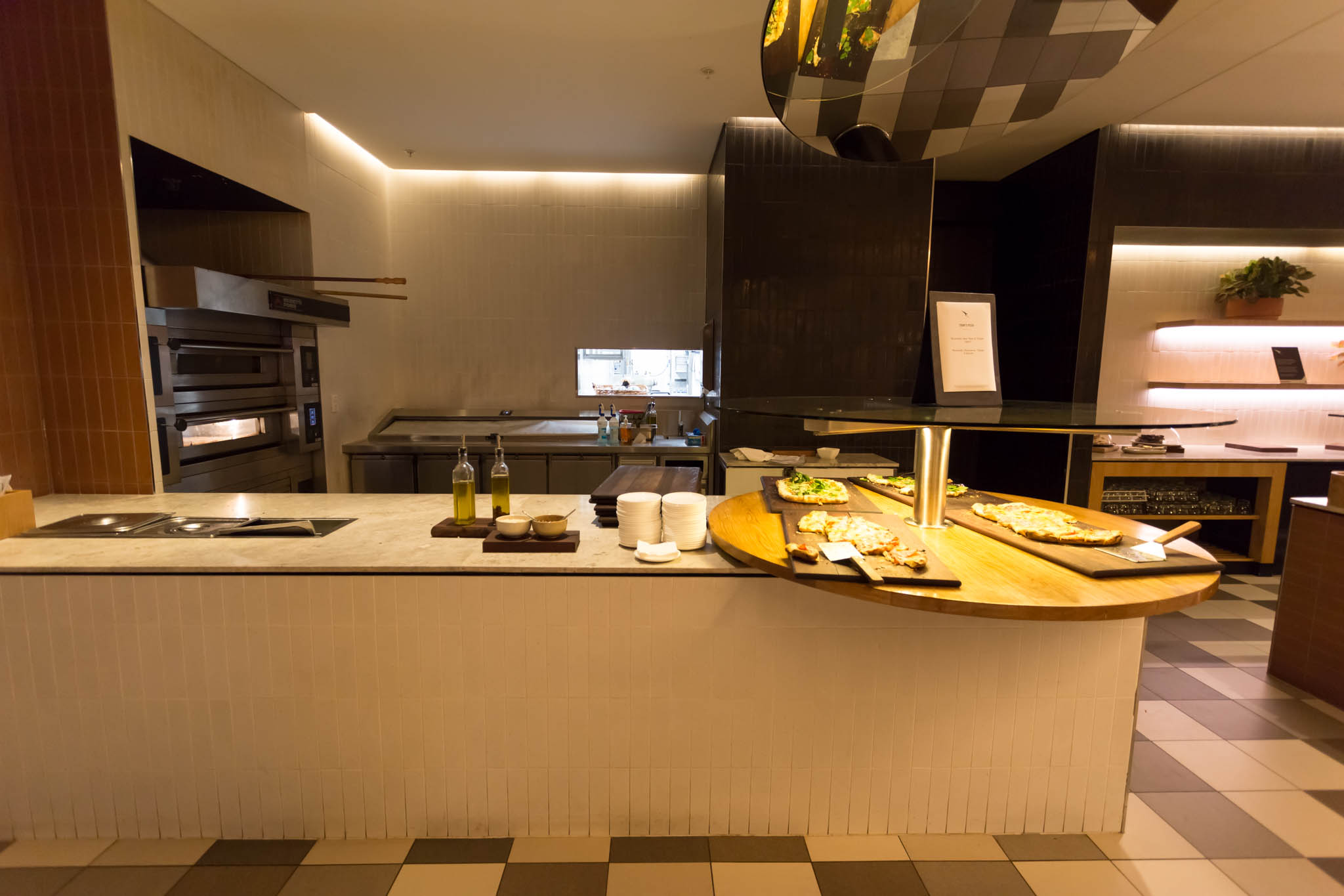 a kitchen with pizzas on a counter