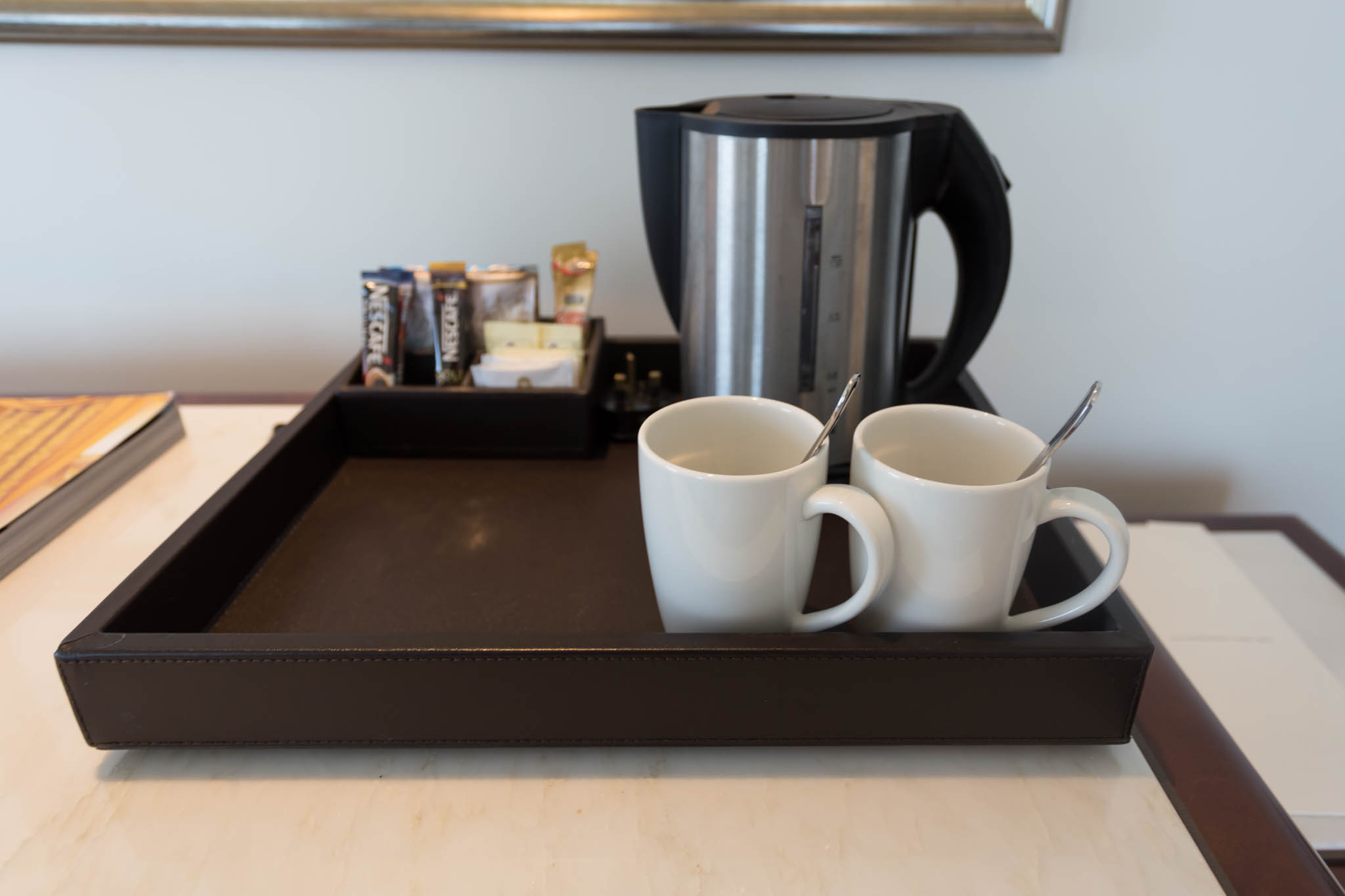 a tray with two cups and a coffee pot