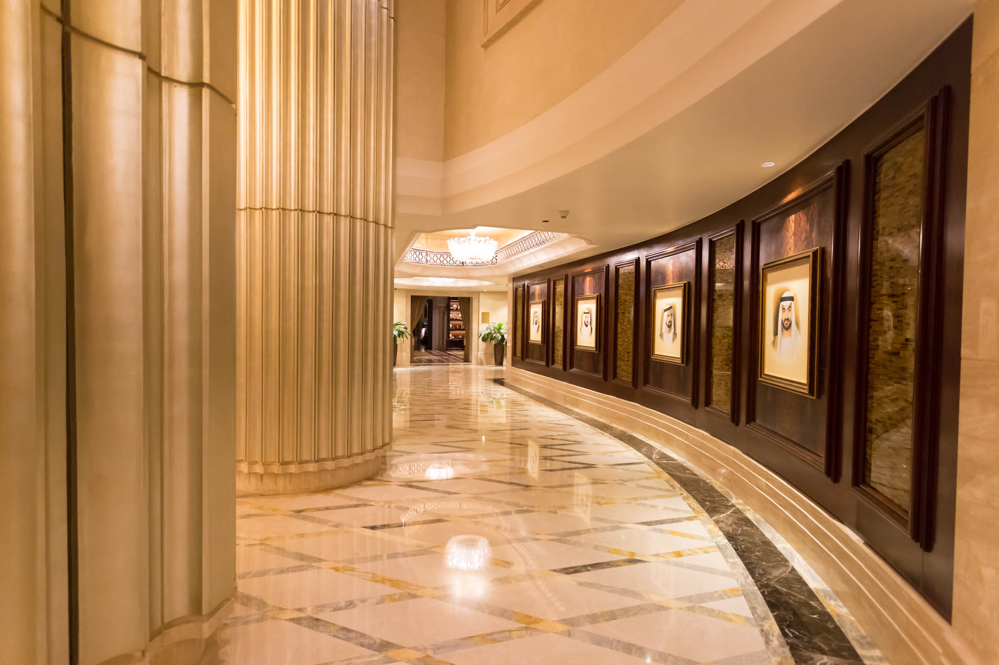 a hallway with marble floor and columns