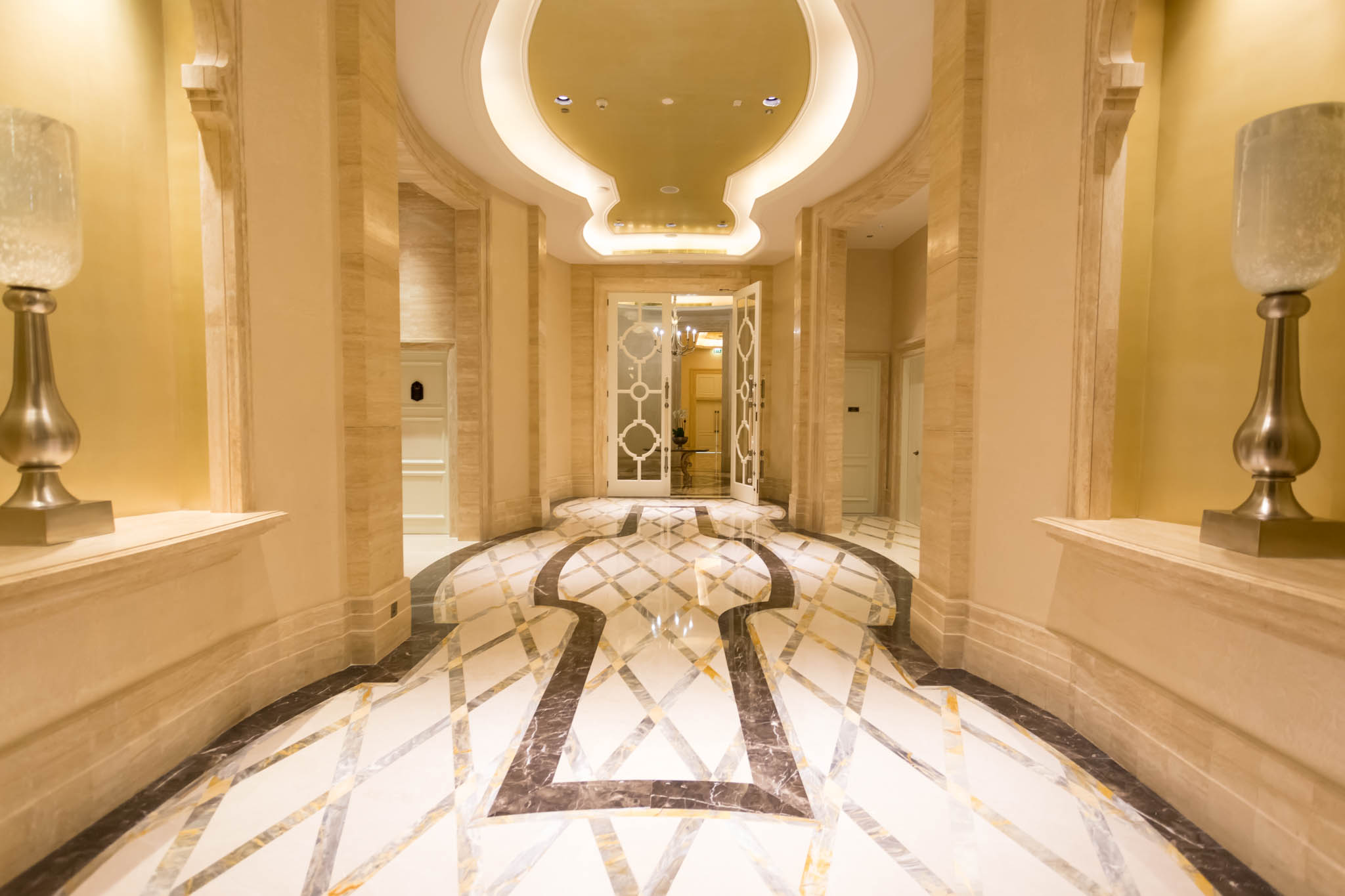 a hallway with a marble floor and a door