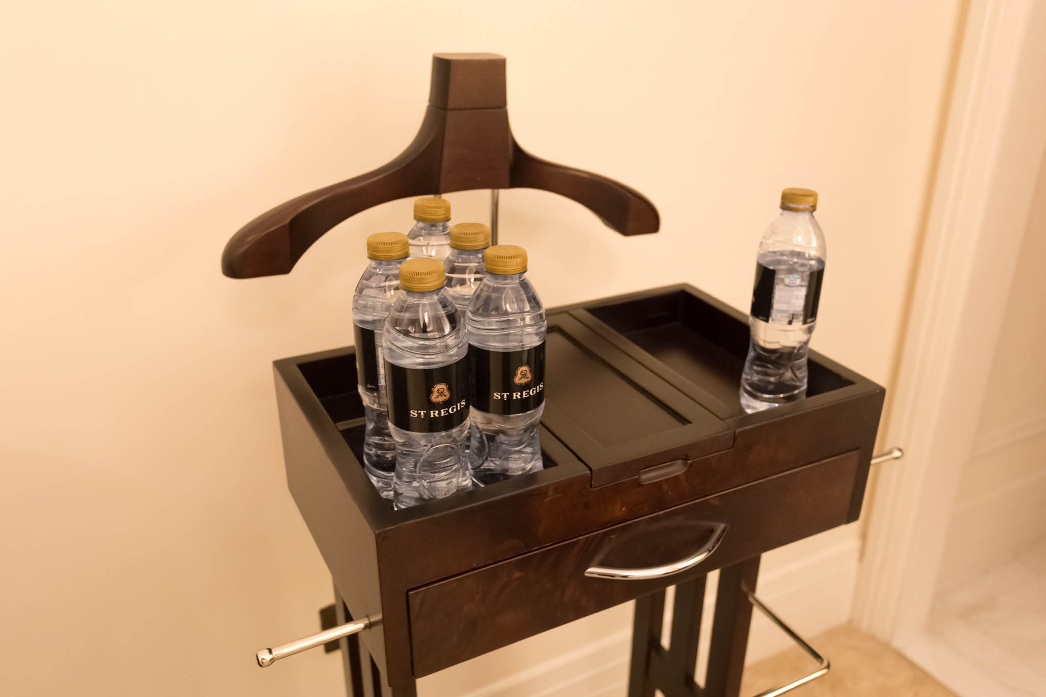 a wooden chest with bottles of water on it