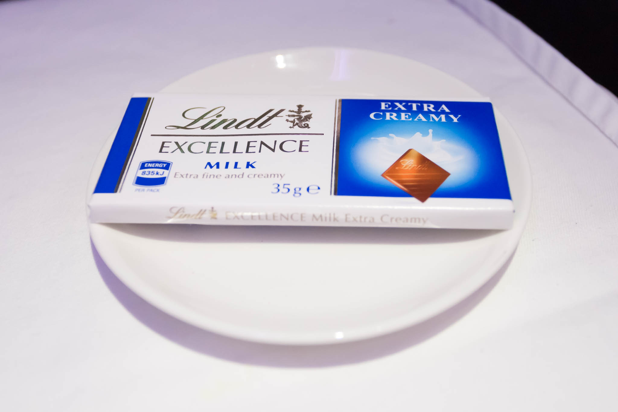 a white plate with a package of chocolate on it