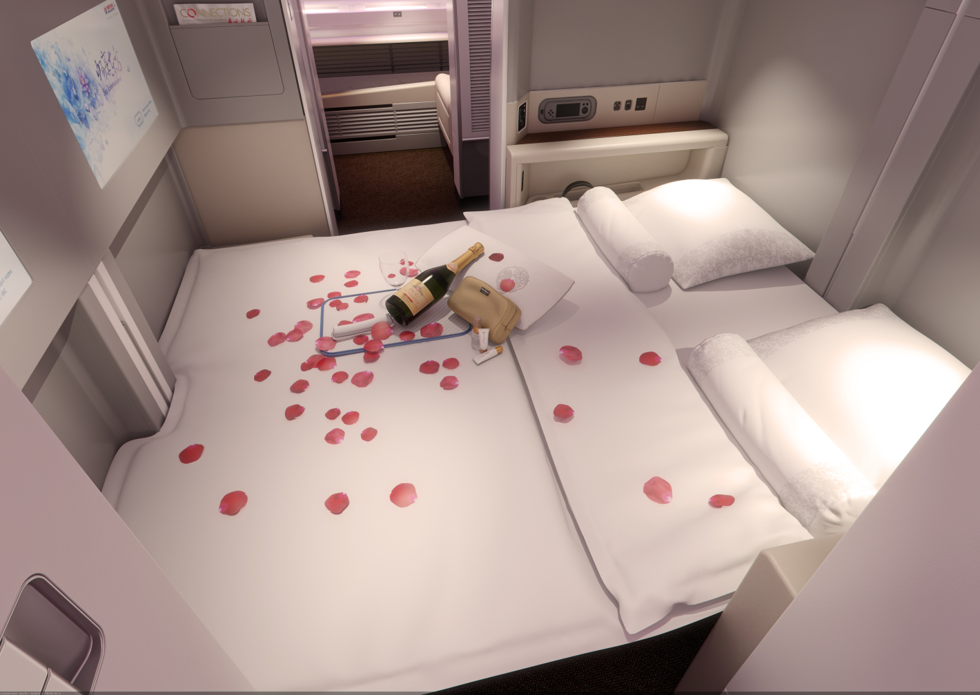 a bed with a bottle and rose petals on it