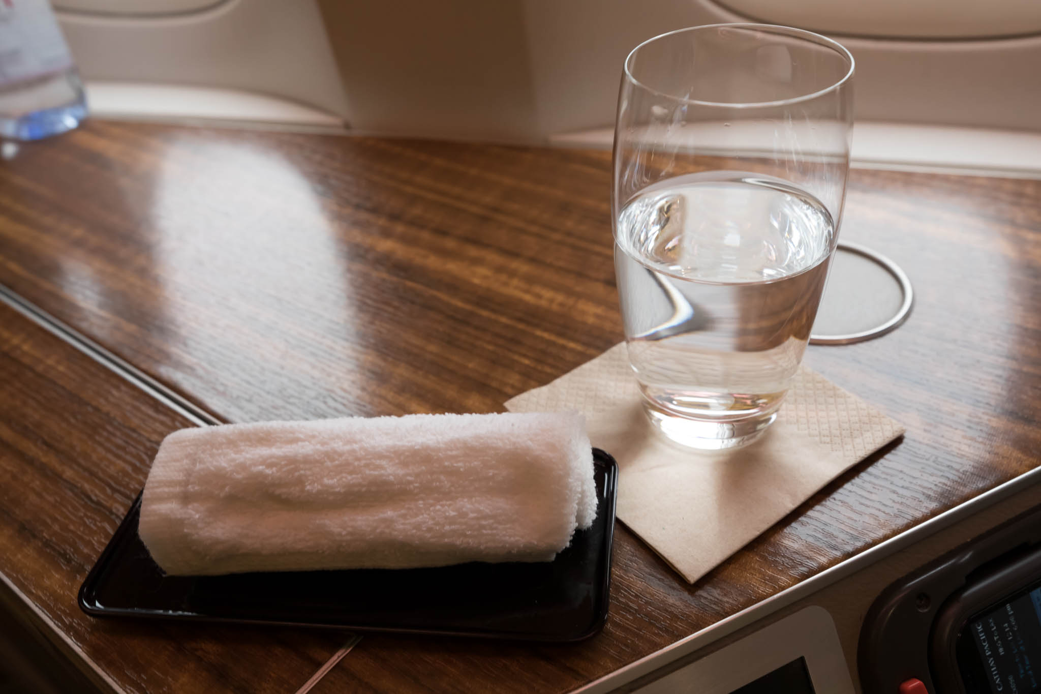 a glass of water and a towel on a table