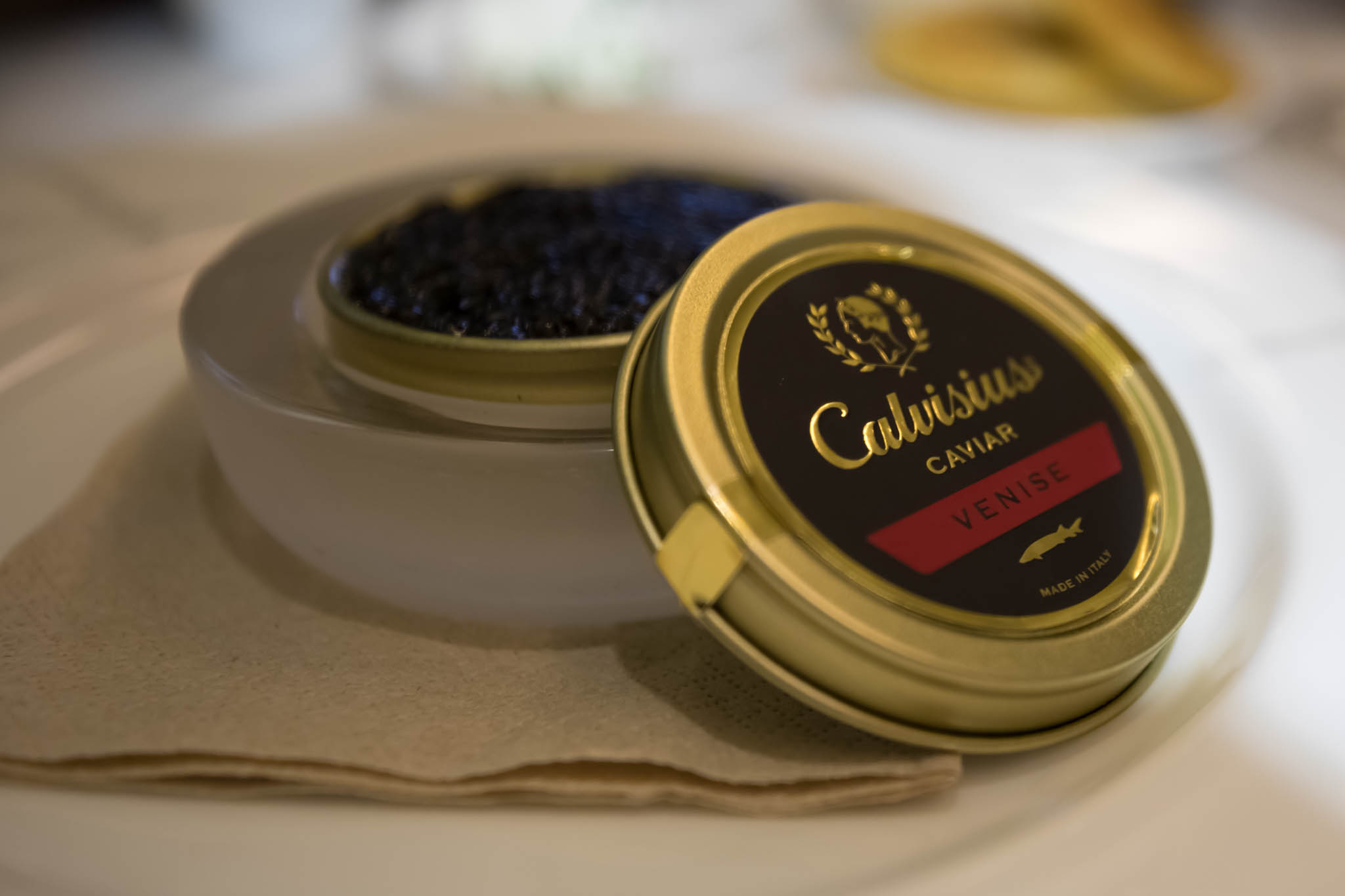 a container of caviar on a napkin