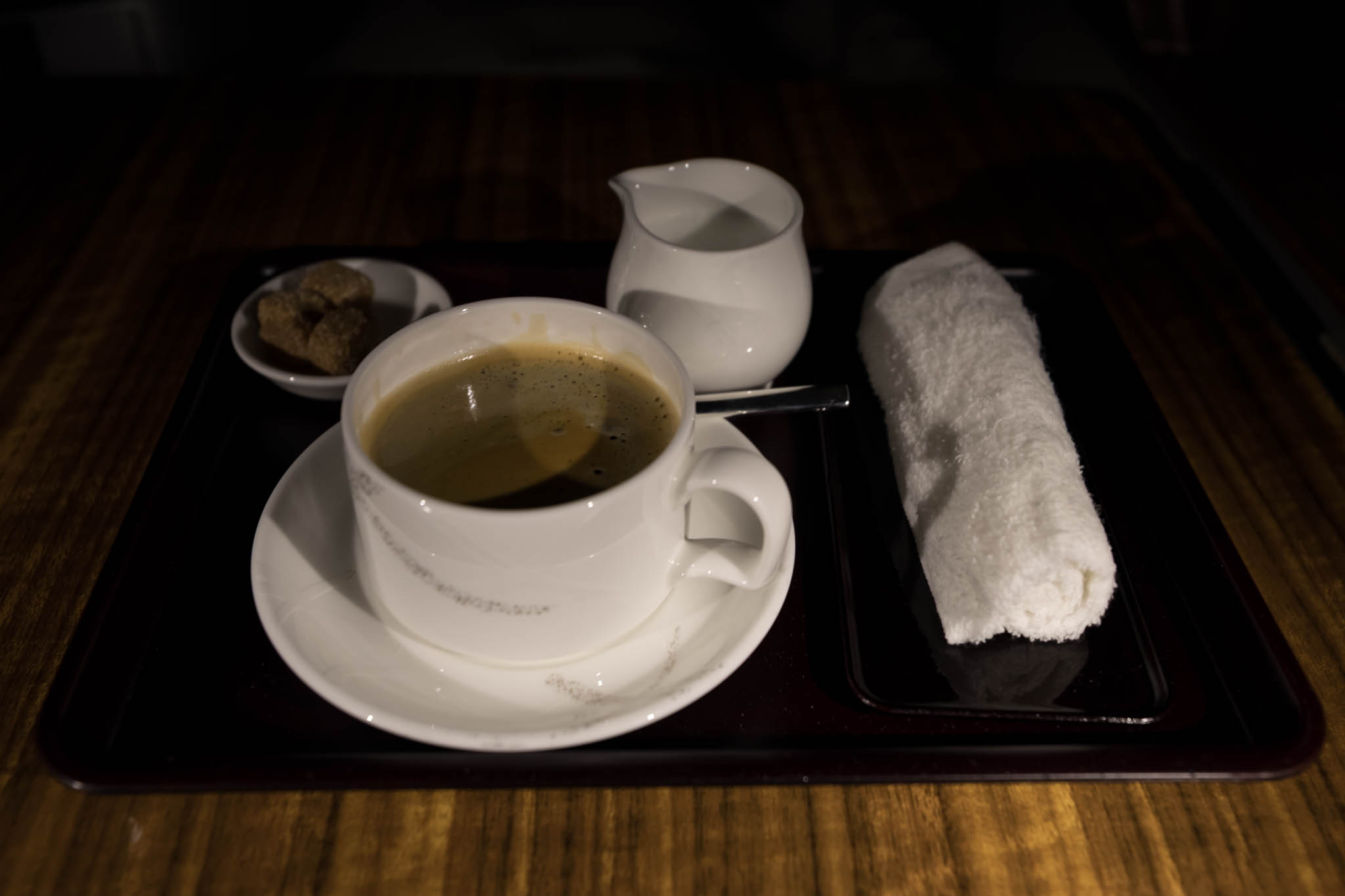 a tray with a cup of coffee and a towel