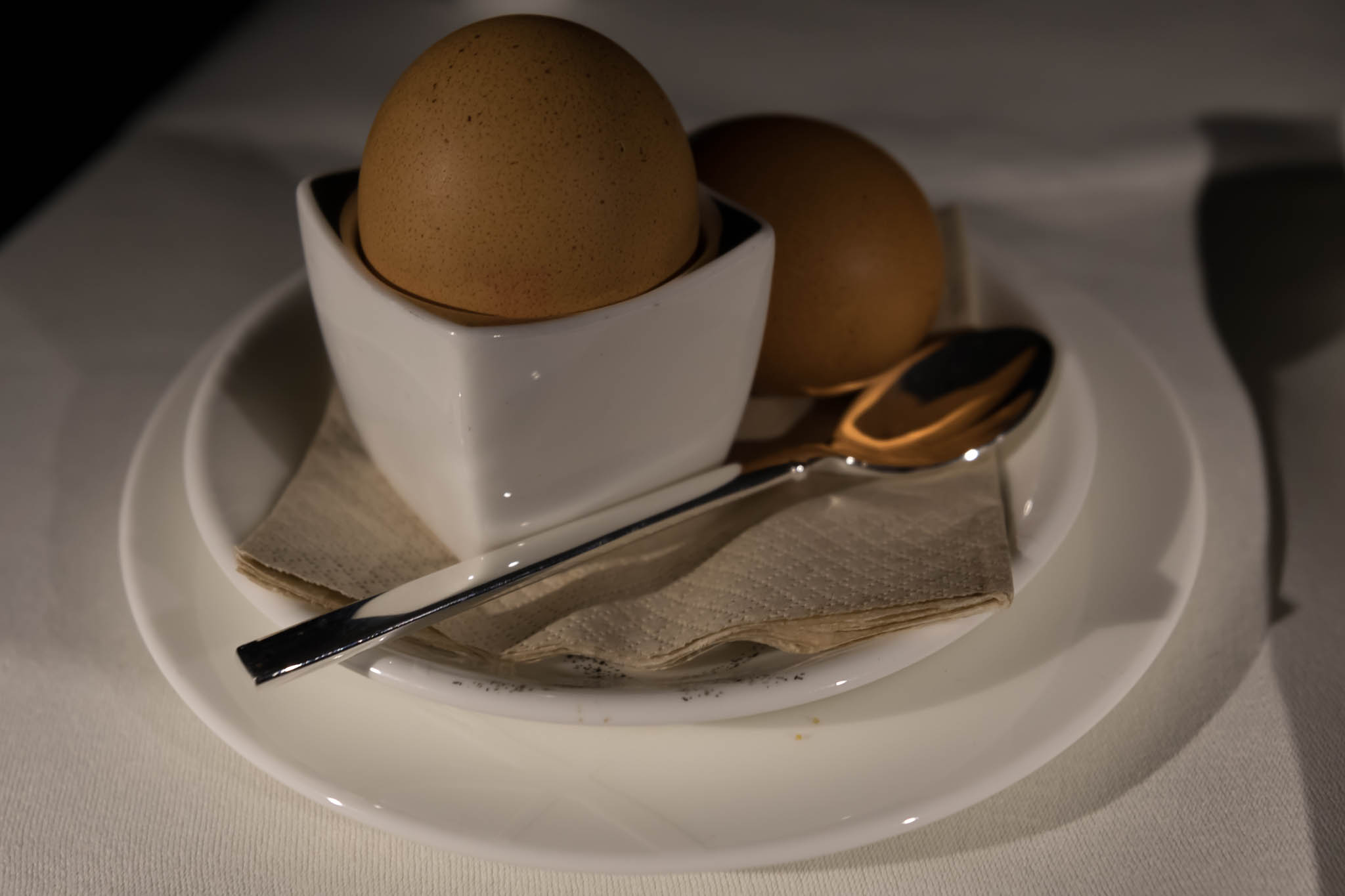 a egg in a cup on a plate