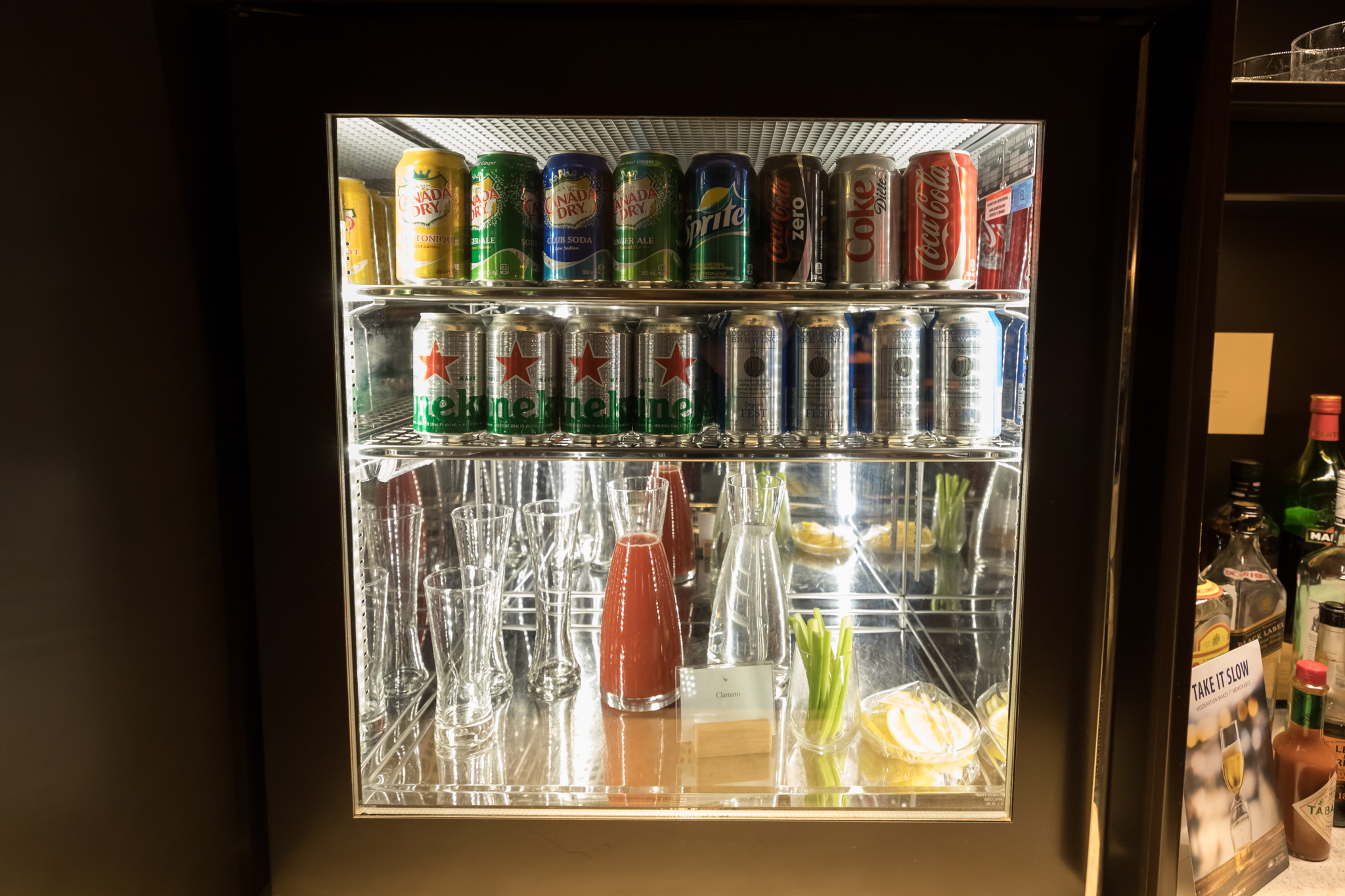 a refrigerator with cans and glasses