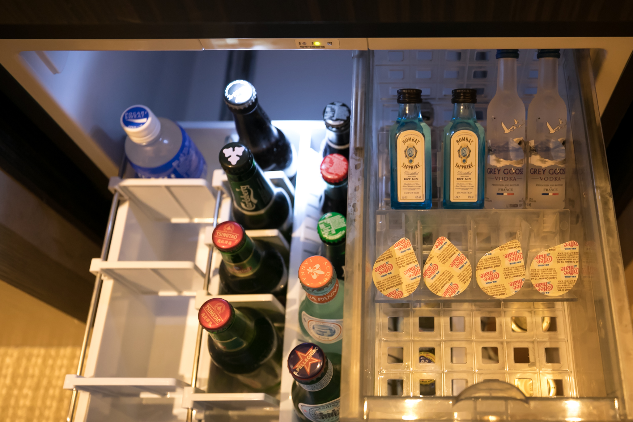 a refrigerator with bottles and drinks