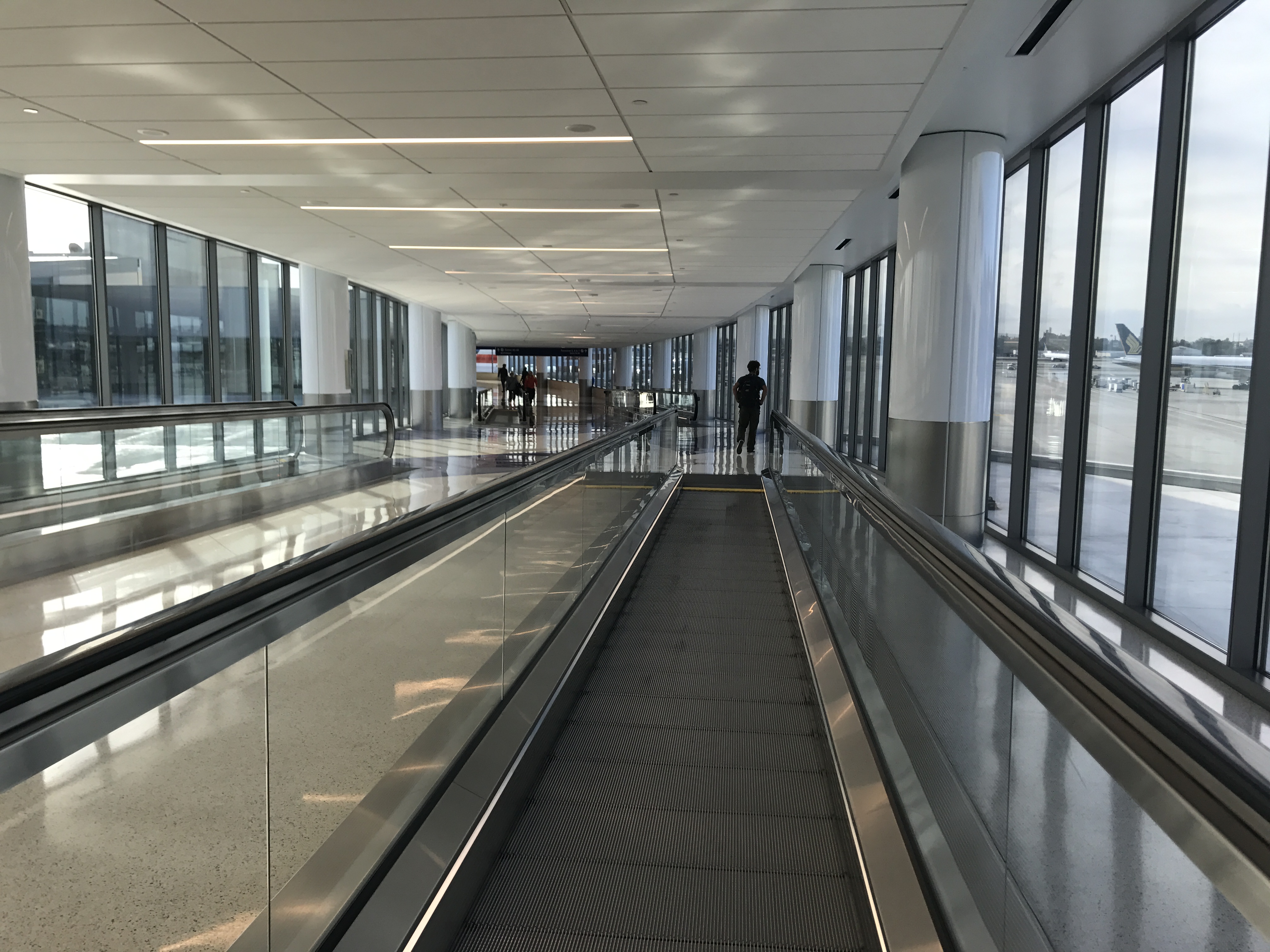 a large airport terminal with a moving walkway