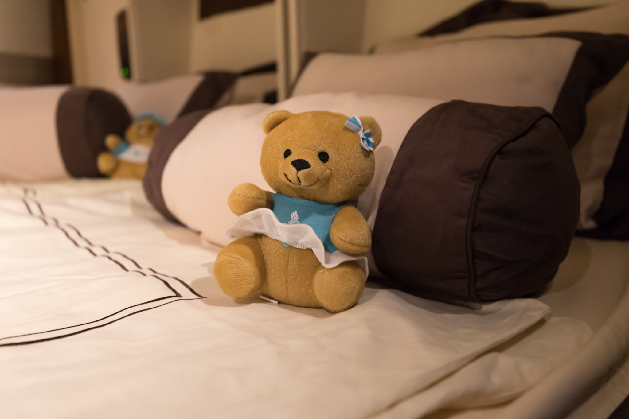 a stuffed bear on a bed