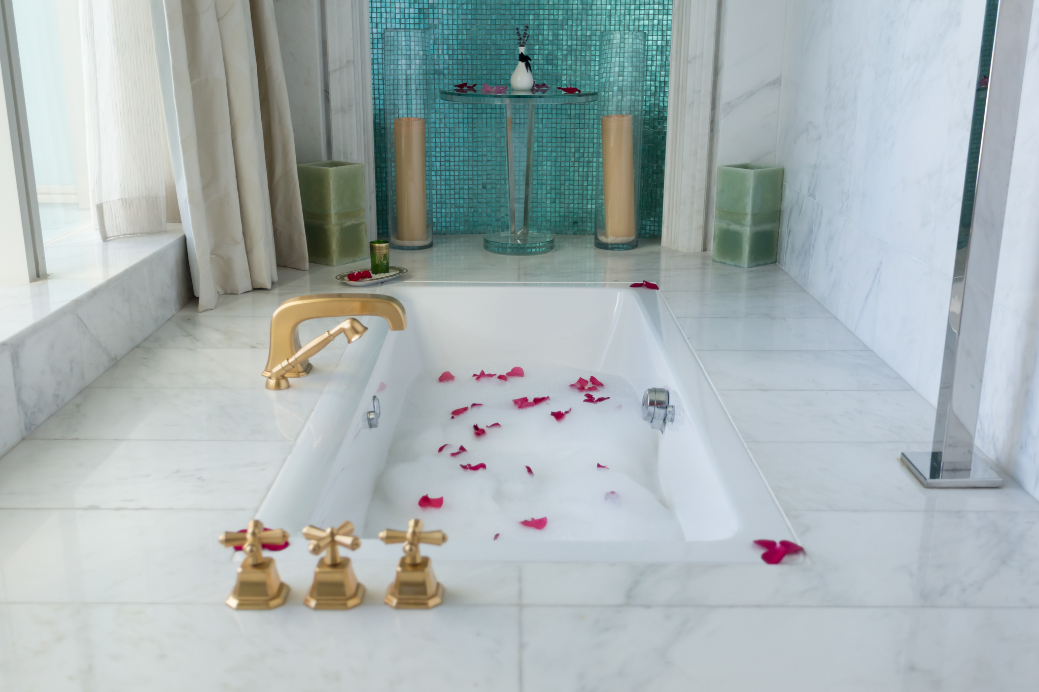 a bathtub with rose petals in it