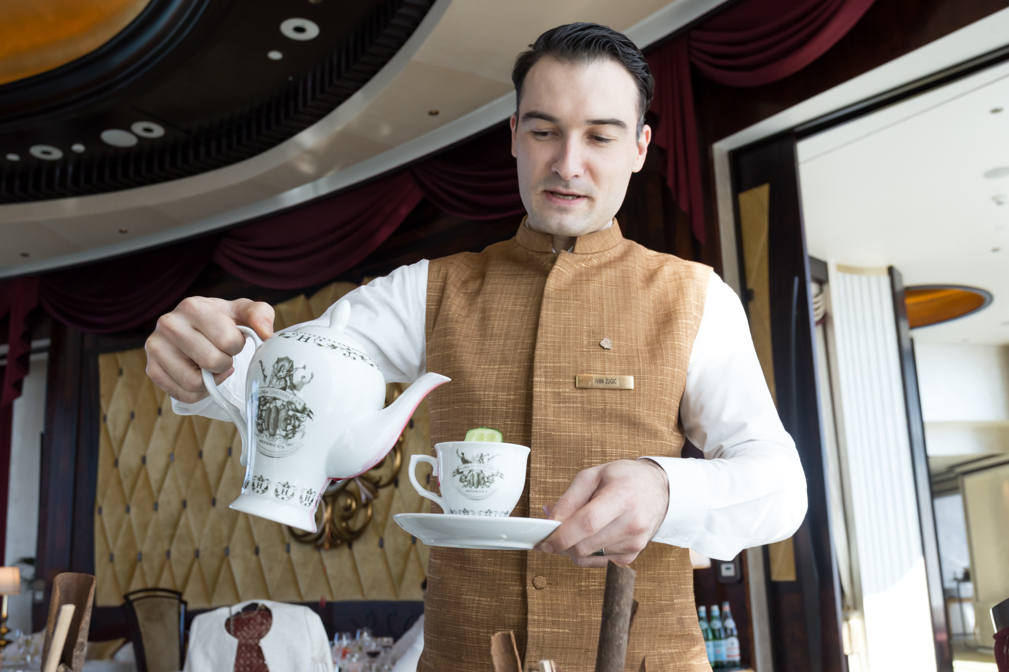 a man pouring tea into a teacup