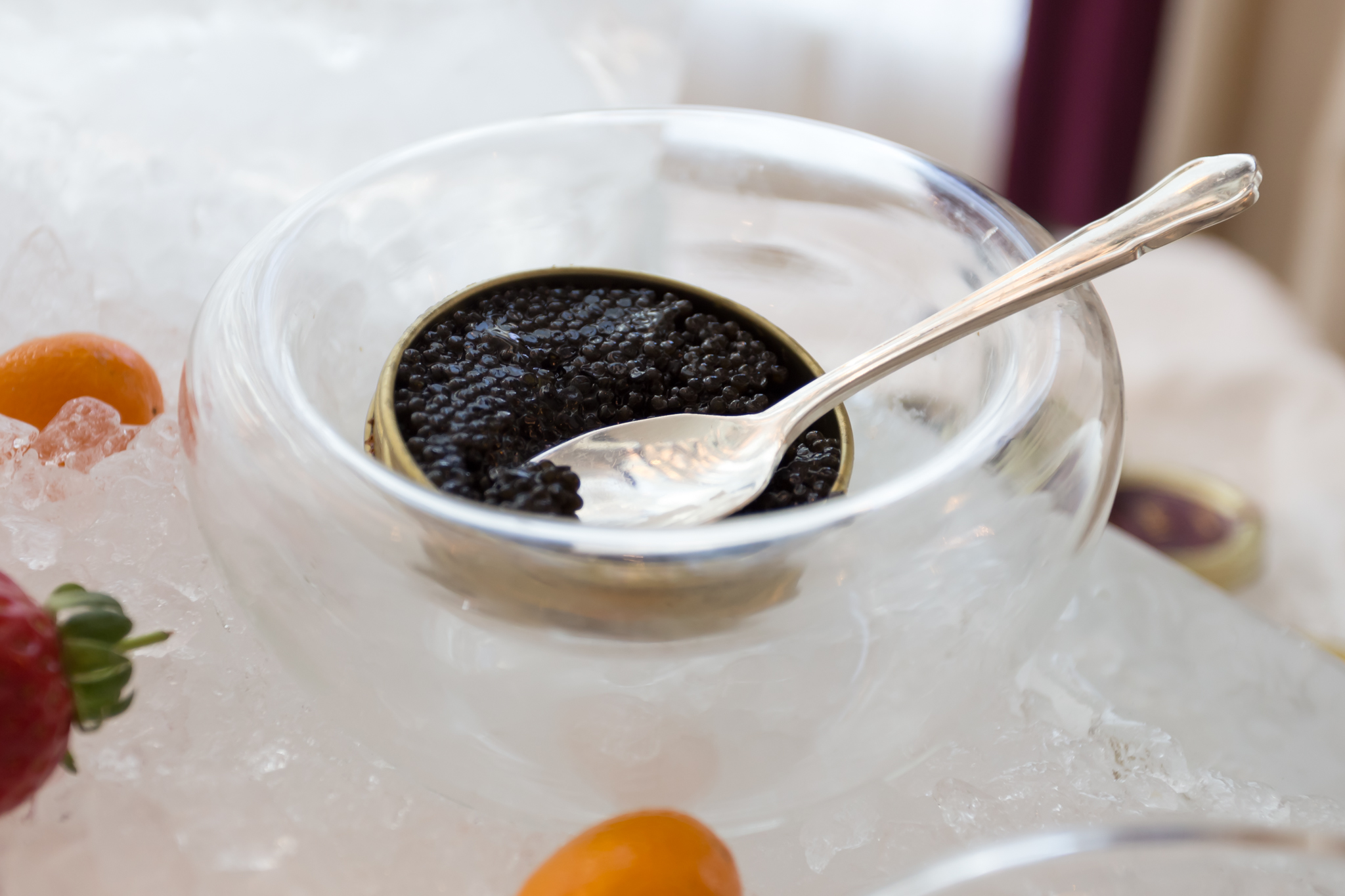 a spoon in a bowl of black caviar