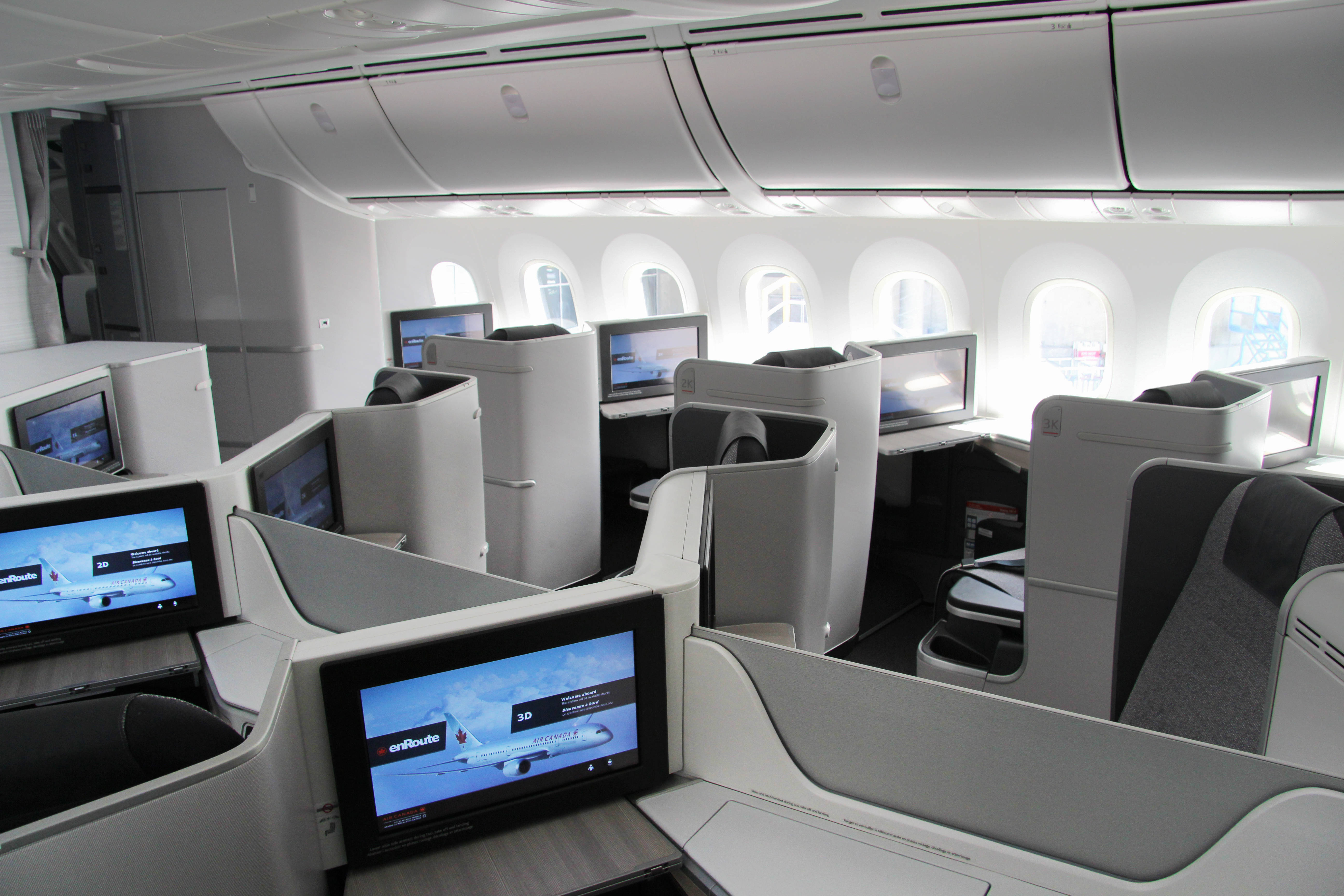 a room with computers and seats in the middle of an airplane