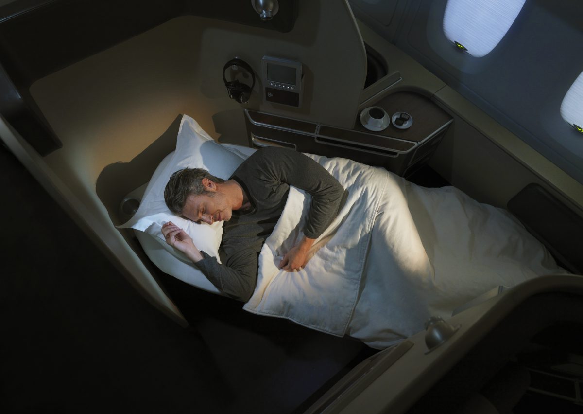 a man sleeping in a plane