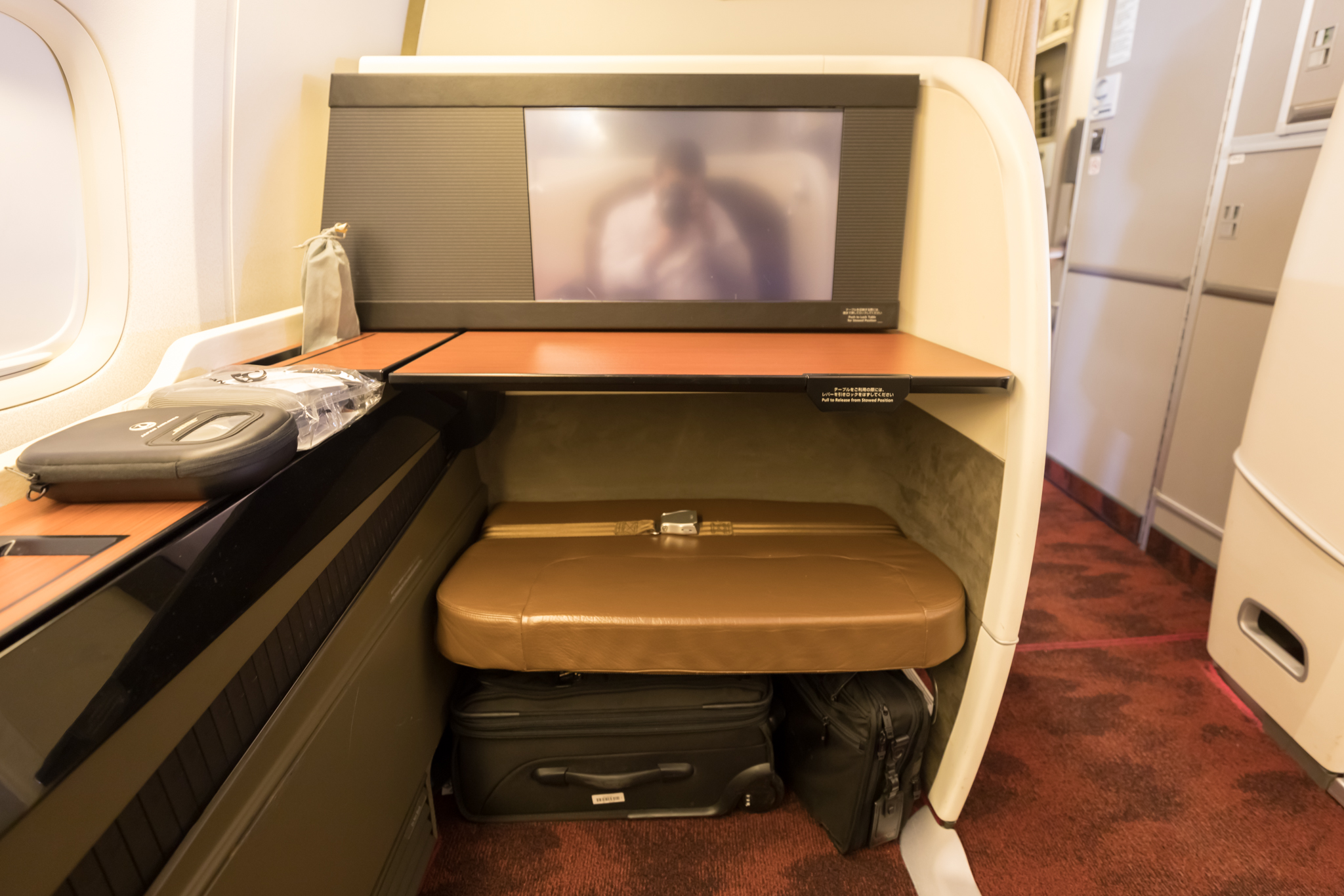 a tv on a table with luggage