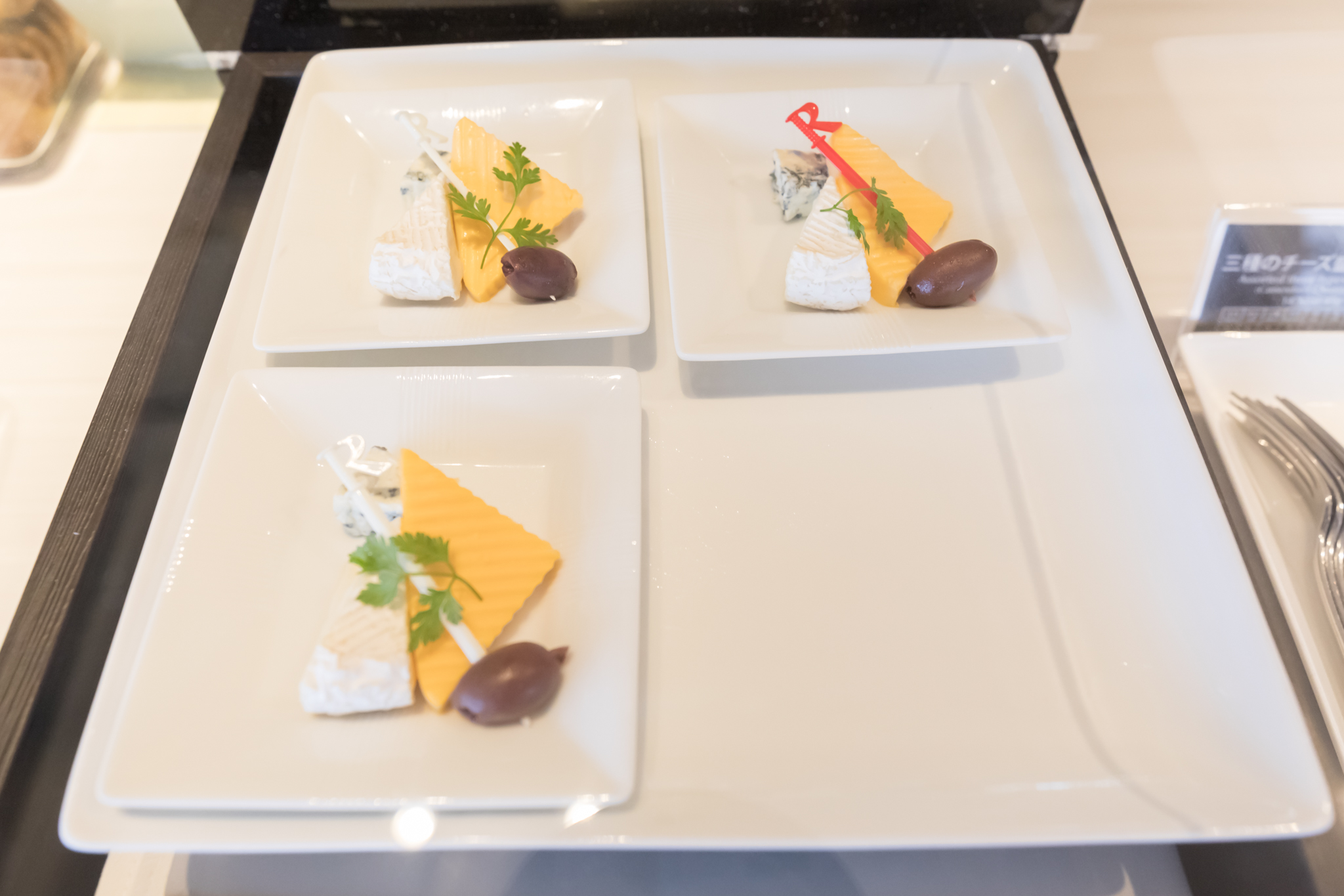 a group of plates with cheese and olives