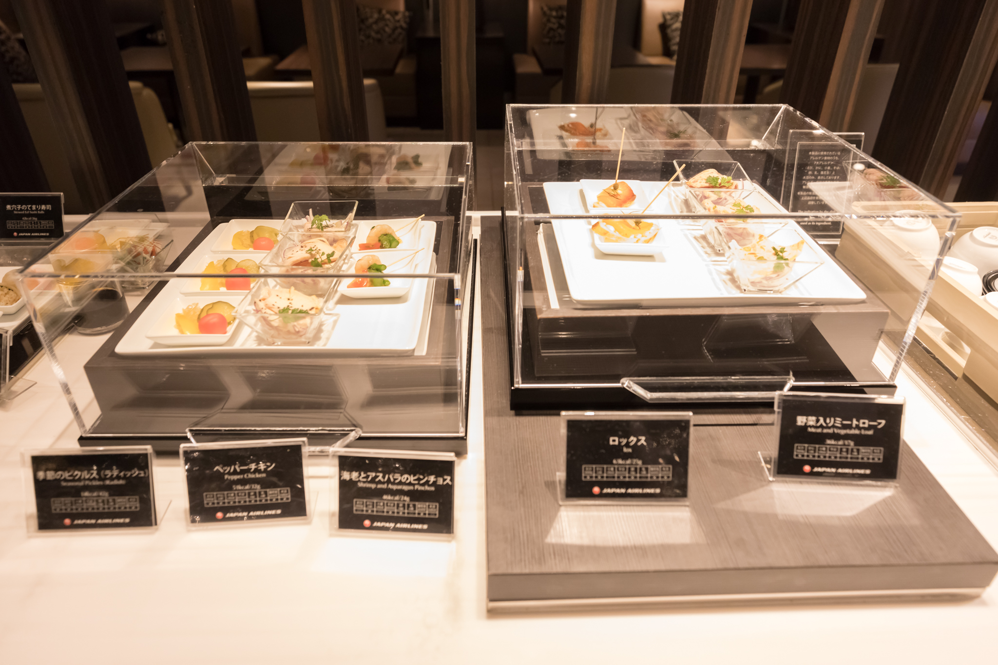 a group of plates of food in a display case