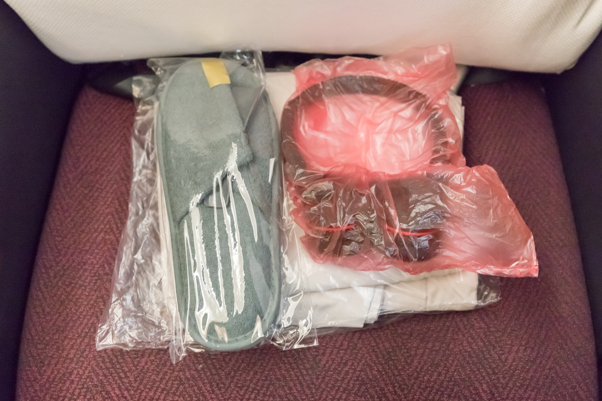 a pair of slippers and headphones in a plastic bag