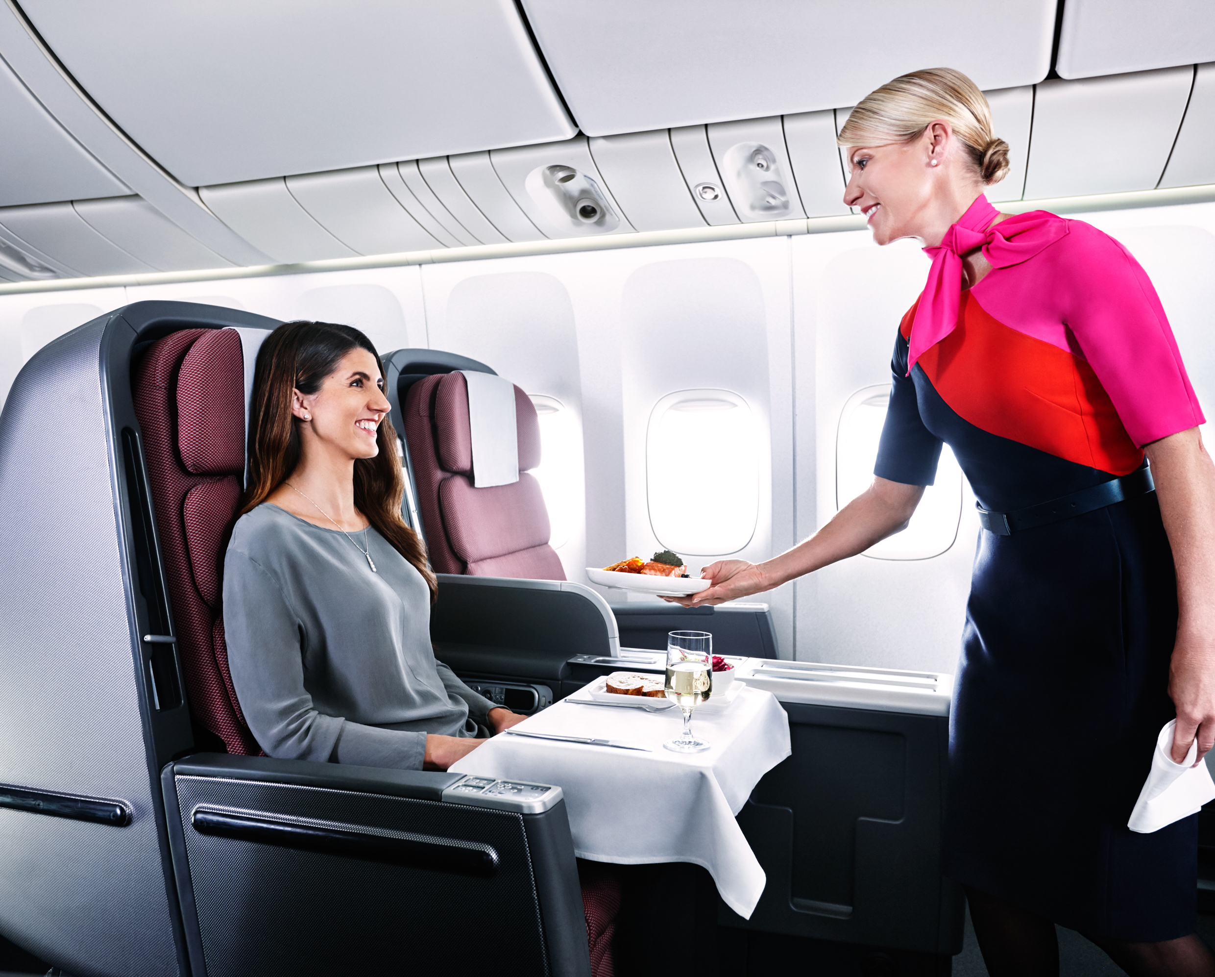 a woman serving a woman in a plane