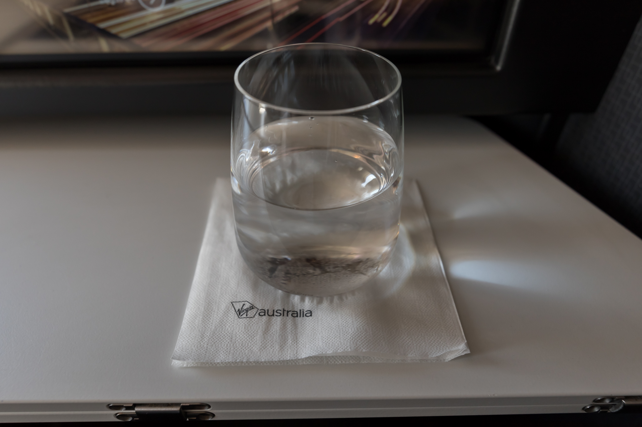 a glass of water on a napkin