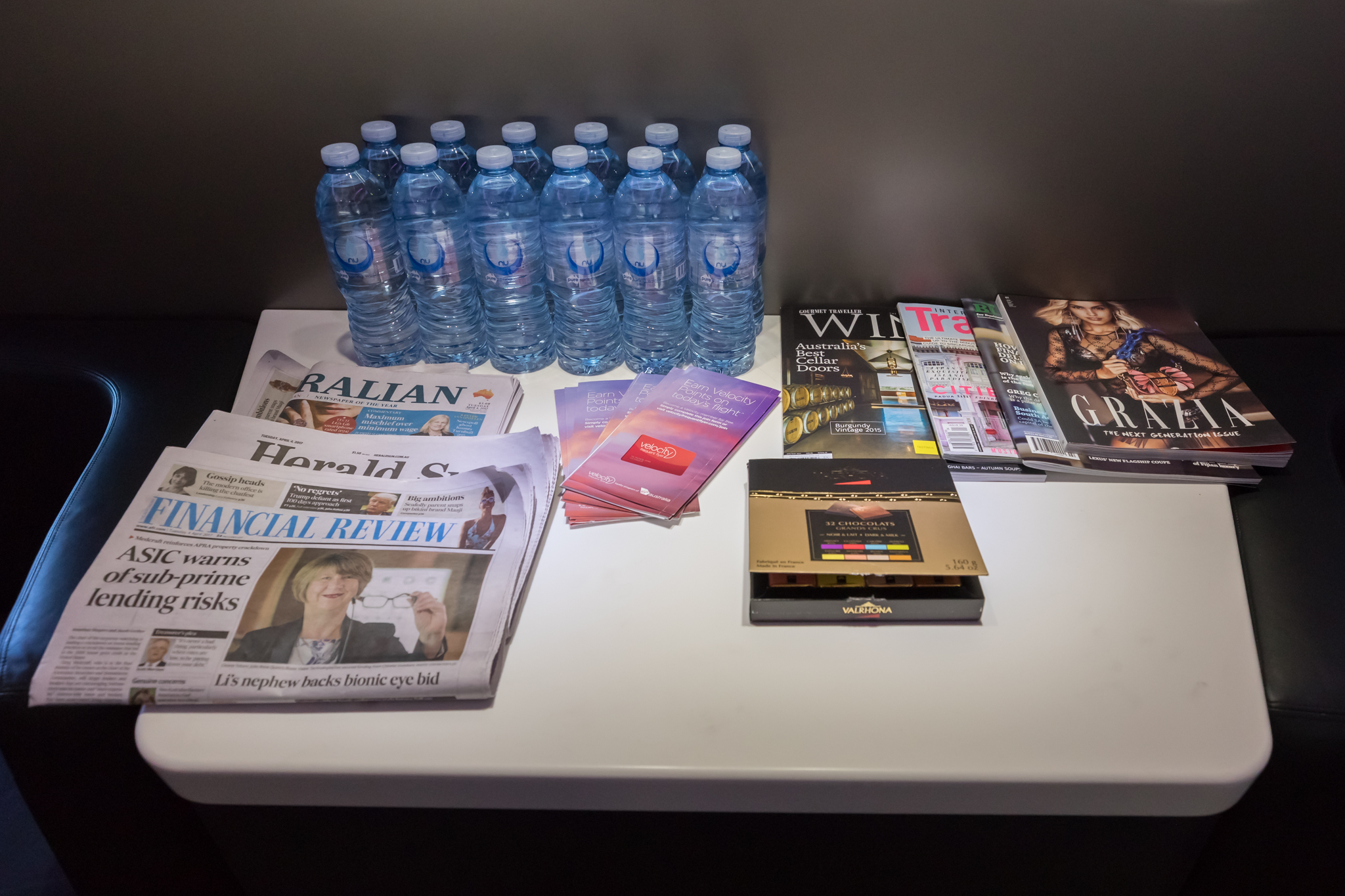 a group of water bottles and magazines on a table