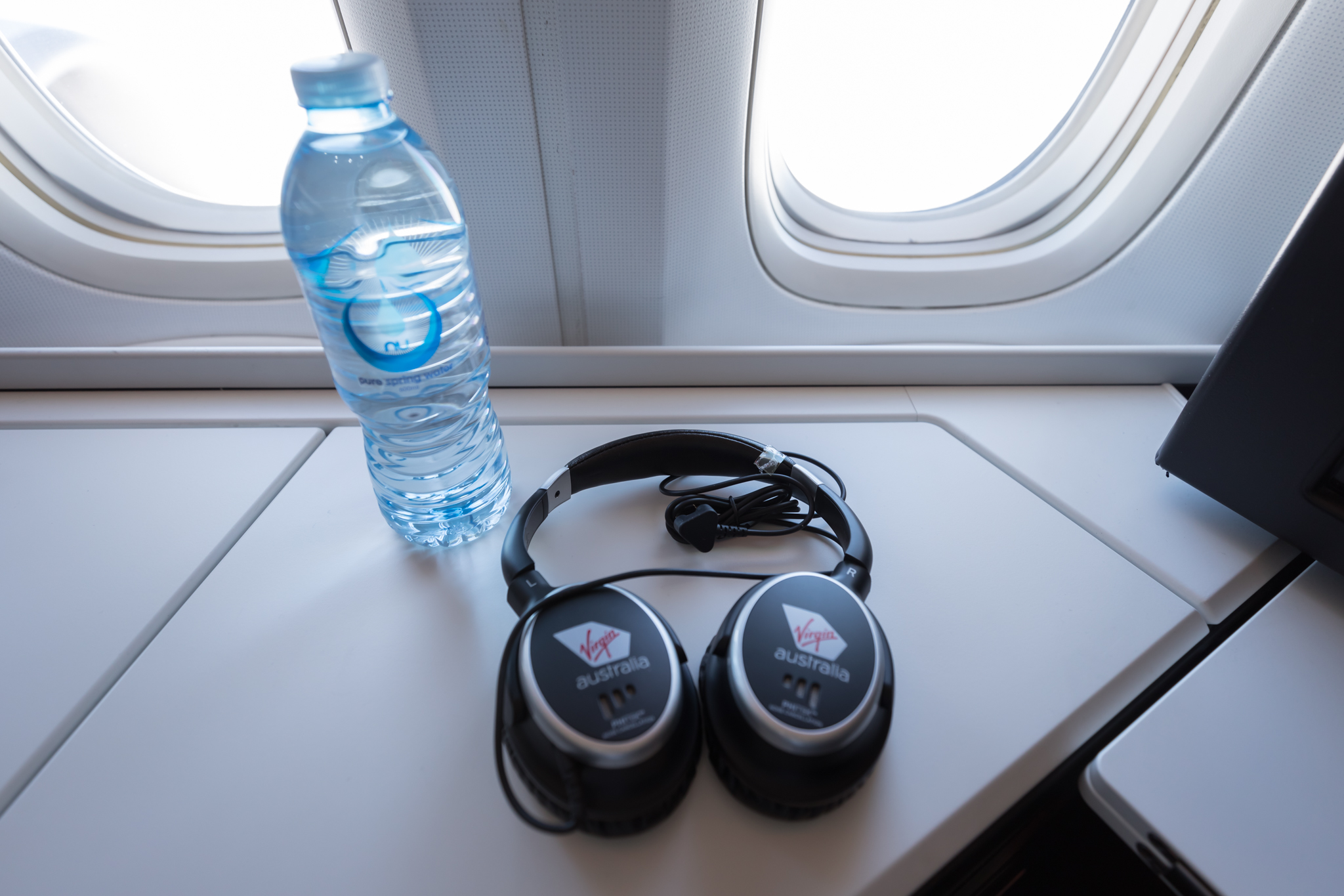 headphones and a bottle of water on a table