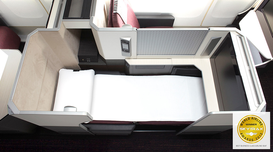 an airplane bed with a white sheet