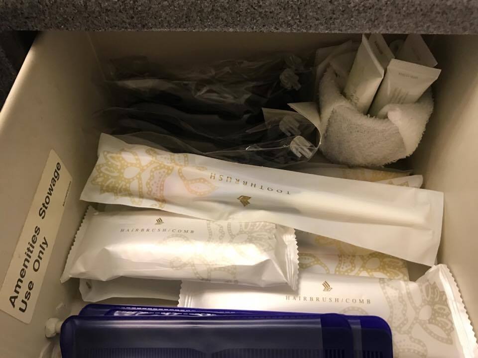 a drawer with toothbrushes and toothpaste