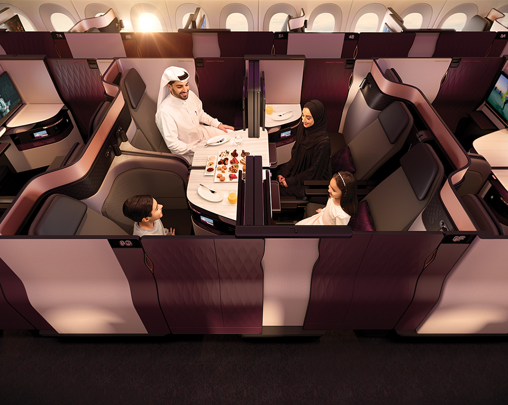 a group of people sitting at a table in a plane