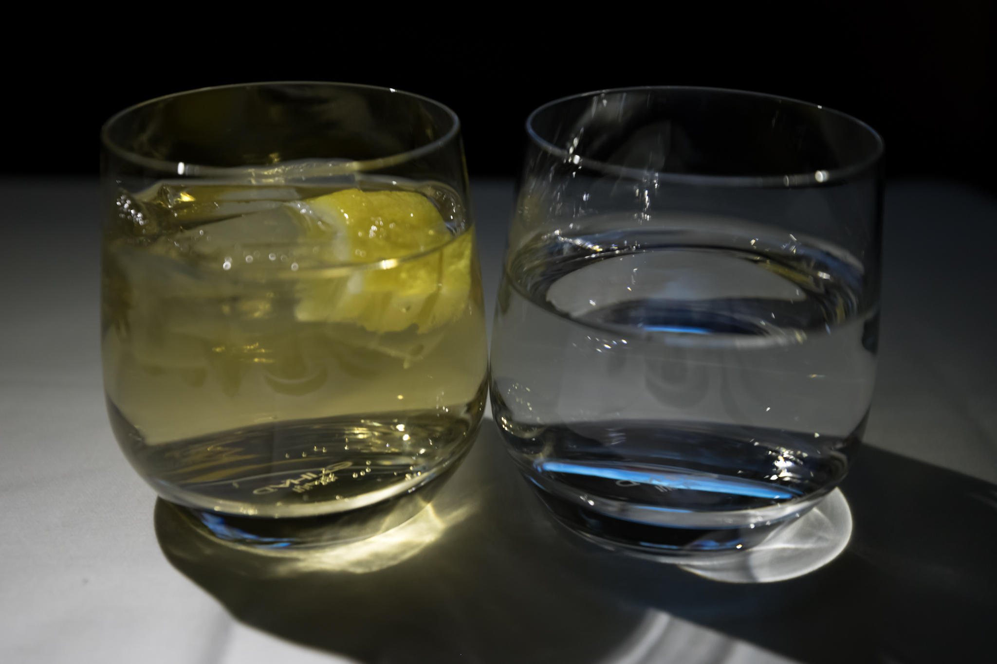 two glasses of water and a lemon