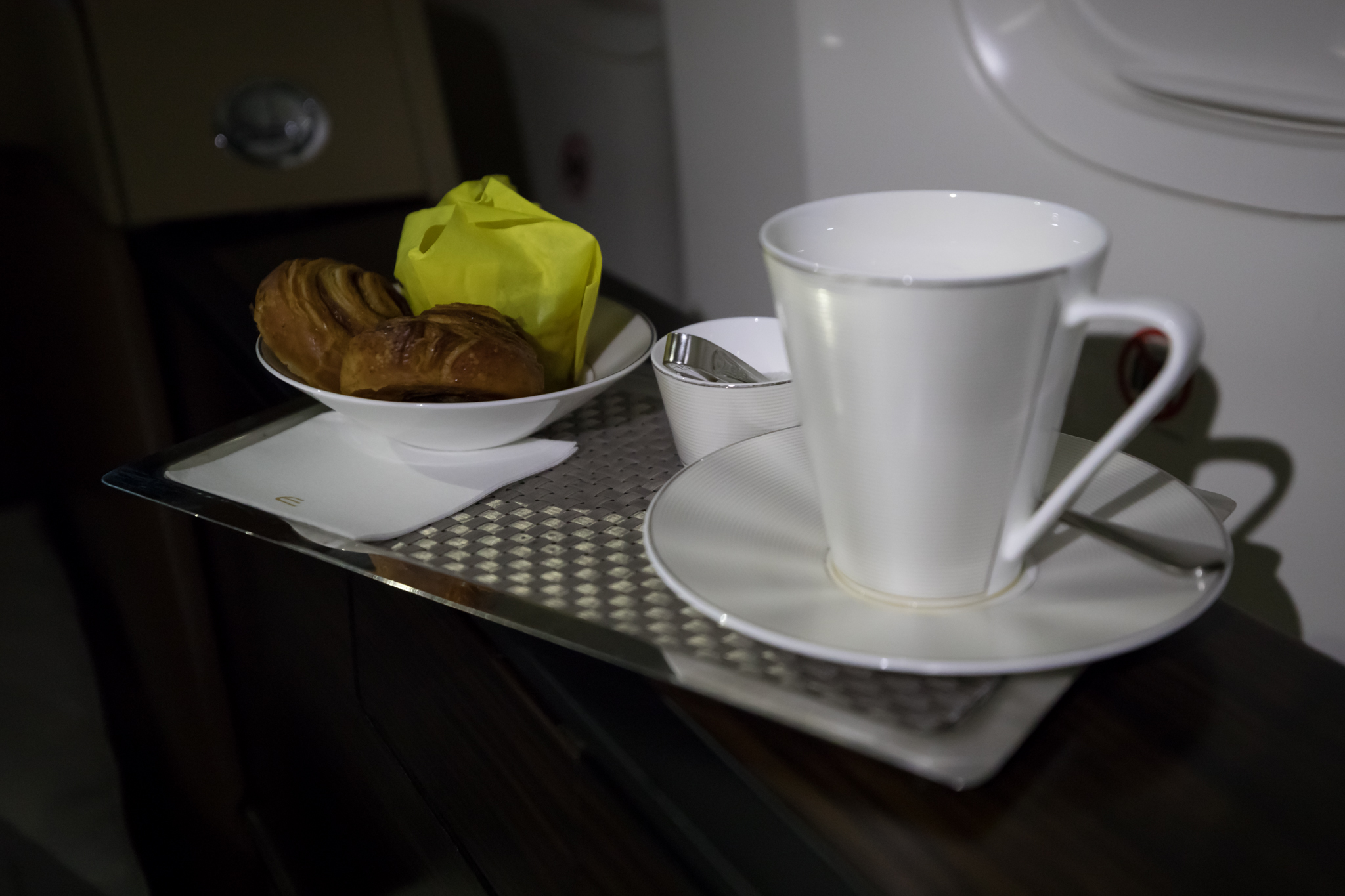a cup and saucer with food on a tray