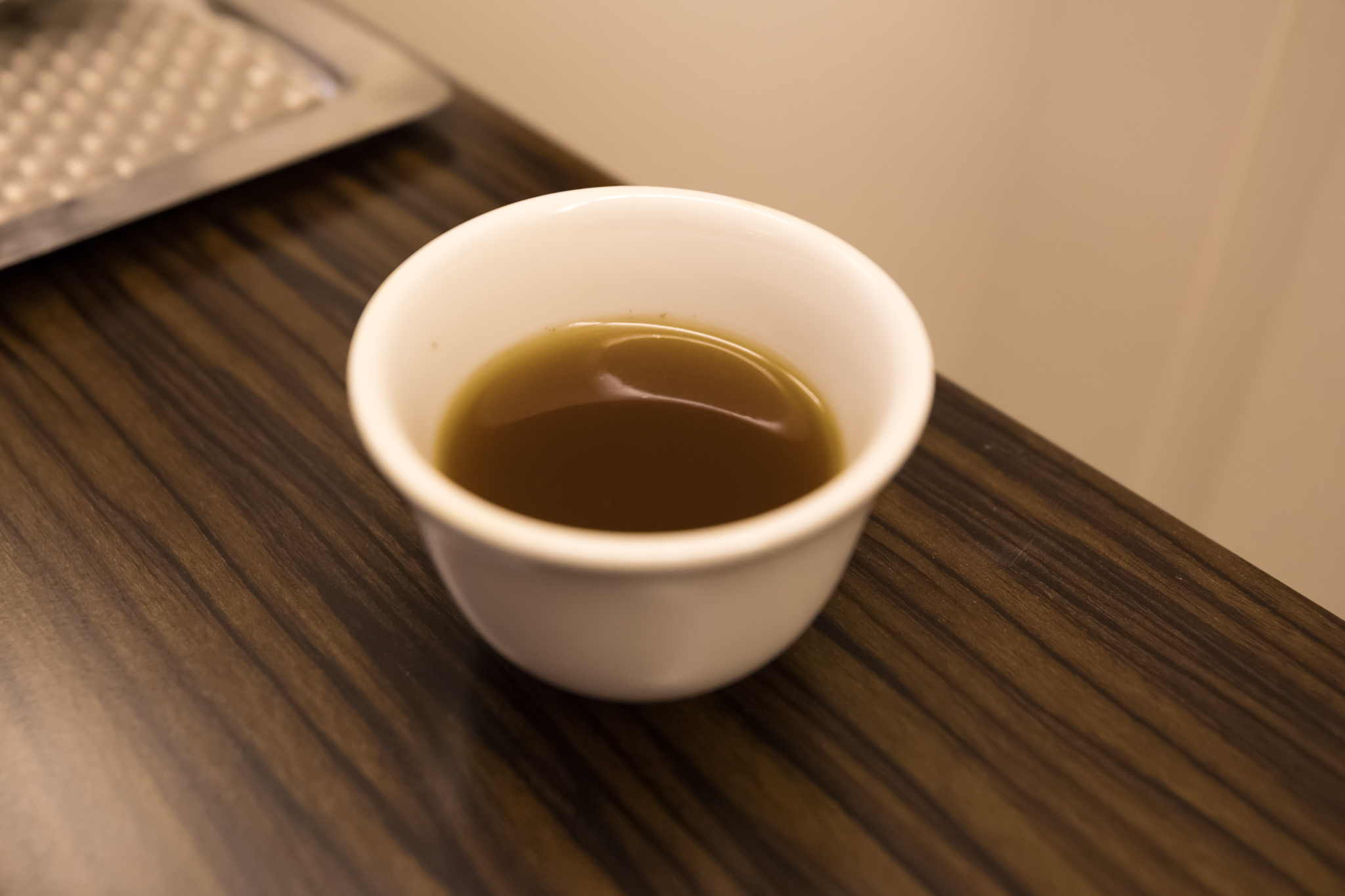 a cup of brown liquid on a table