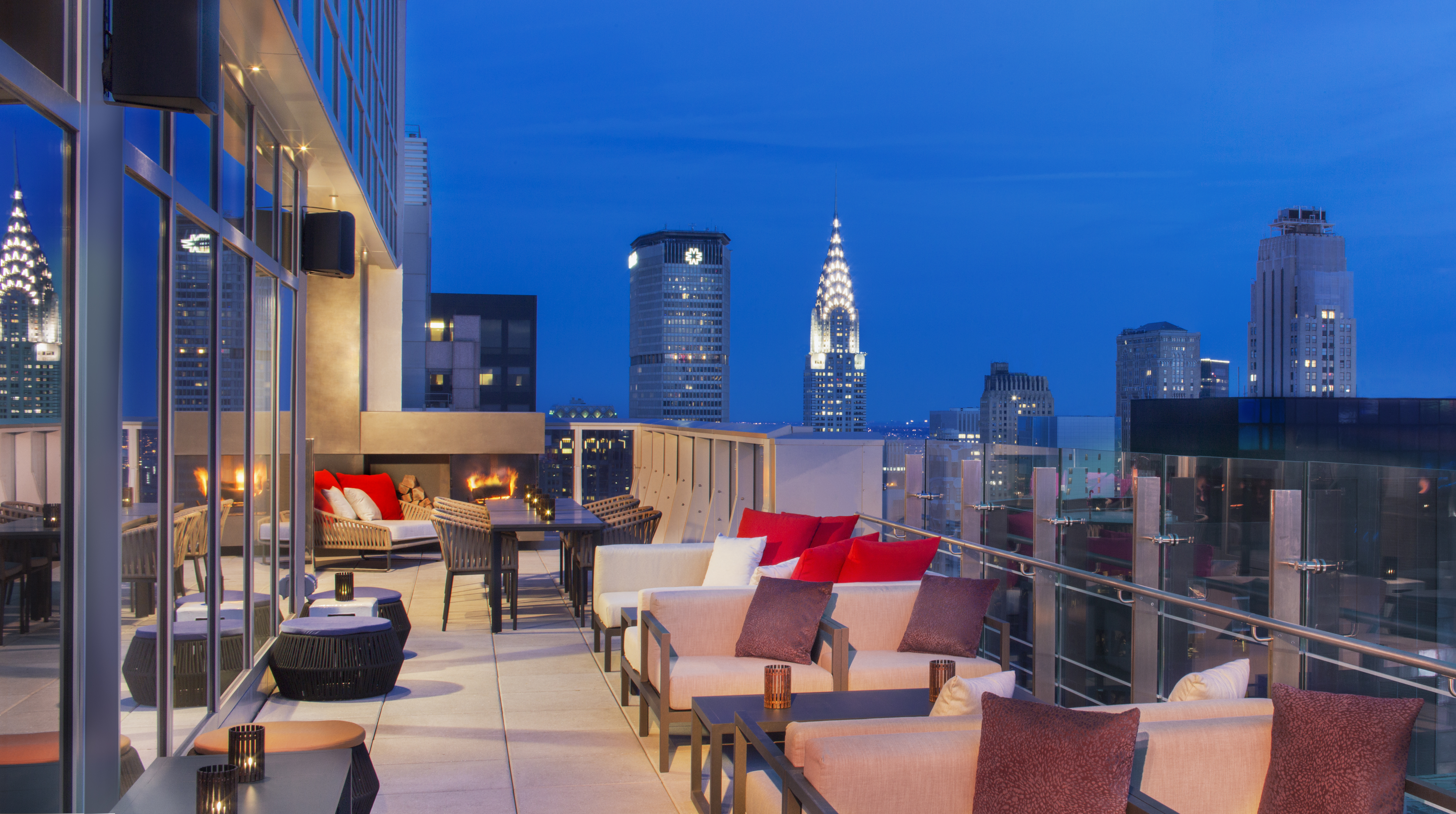 a rooftop patio with a city skyline in the background