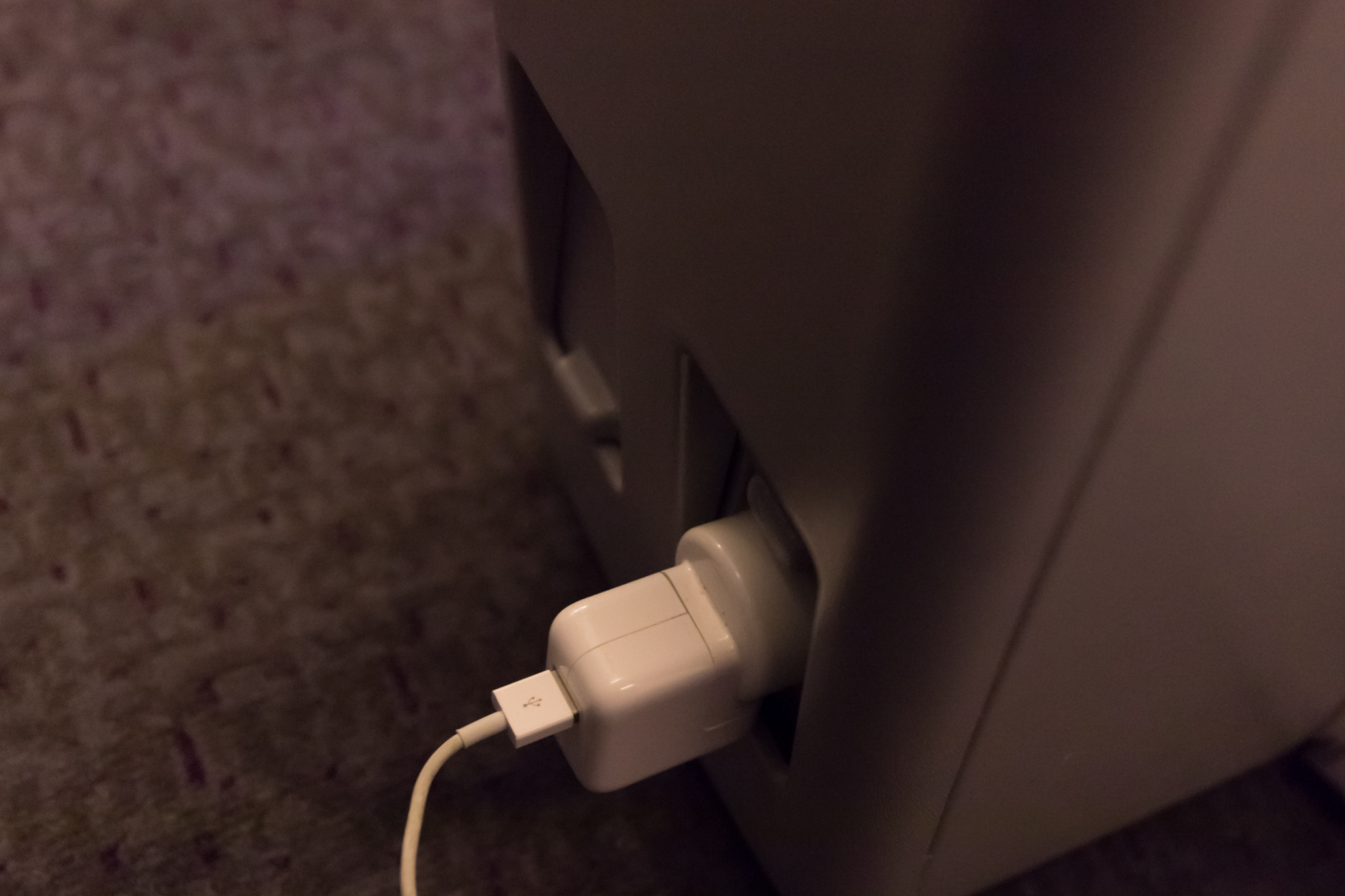 a white usb cable plugged into a rectangular object