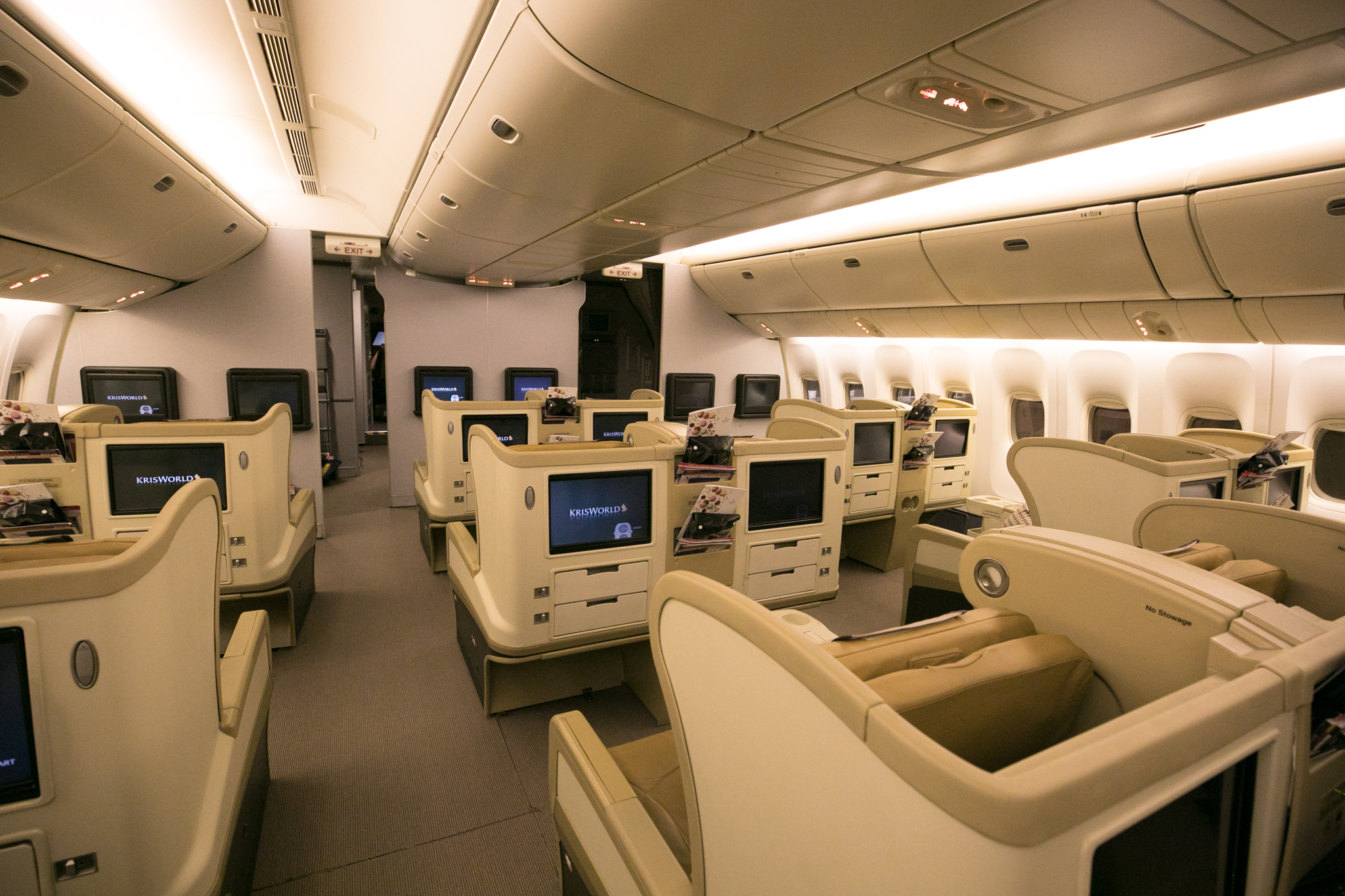 a room with rows of seats and tvs