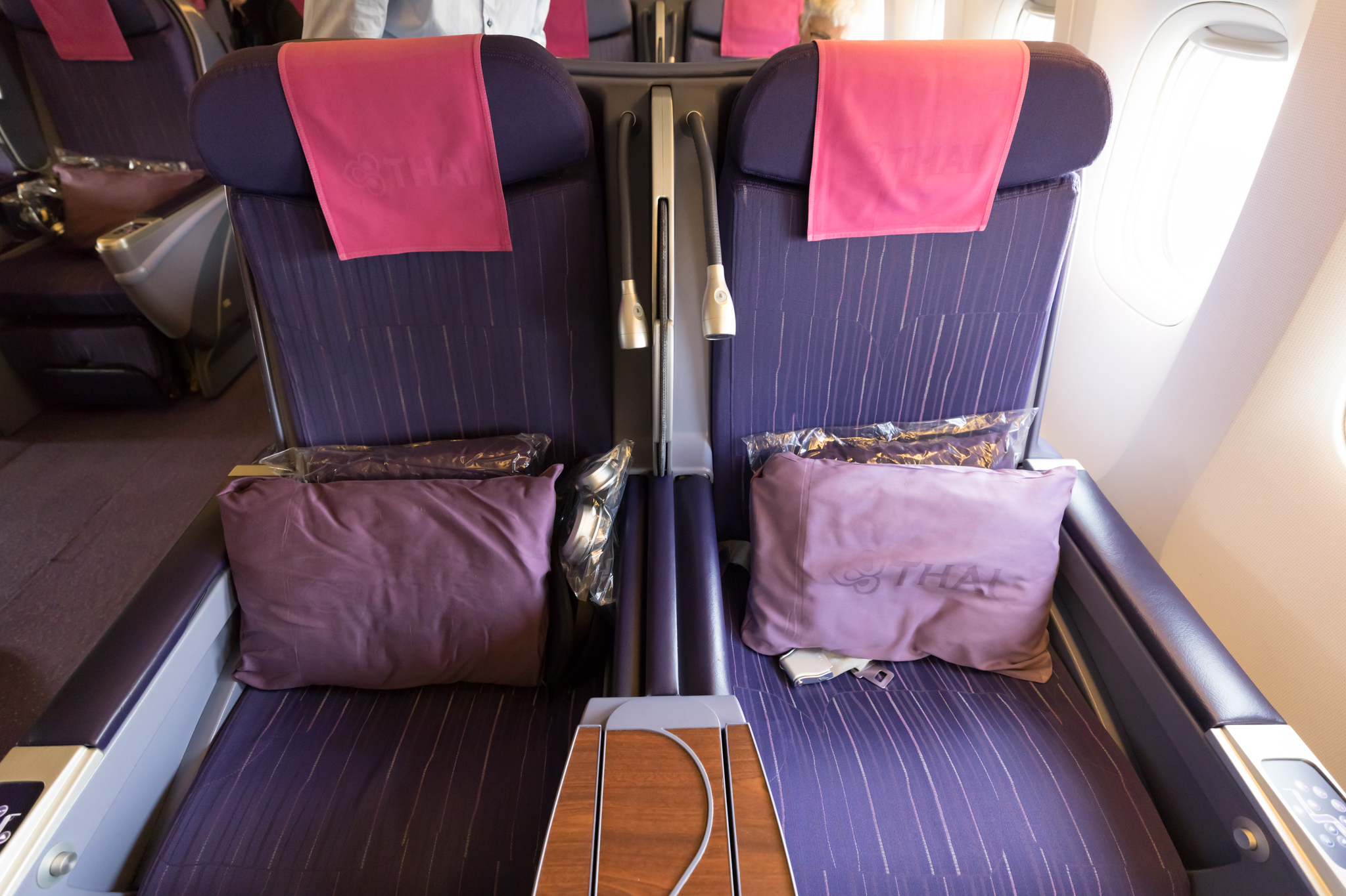 a seat with purple and pink pillows