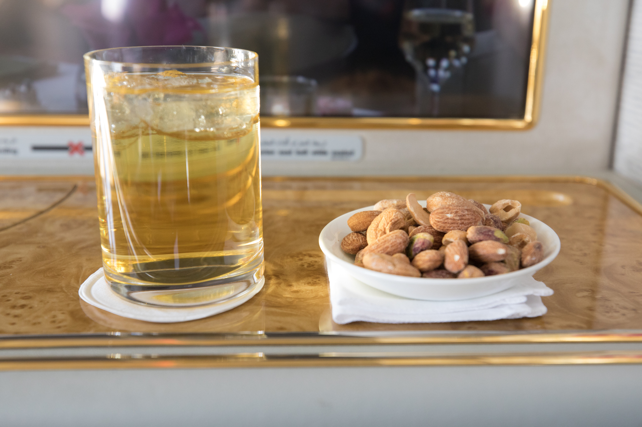 a bowl of nuts and a glass of liquid