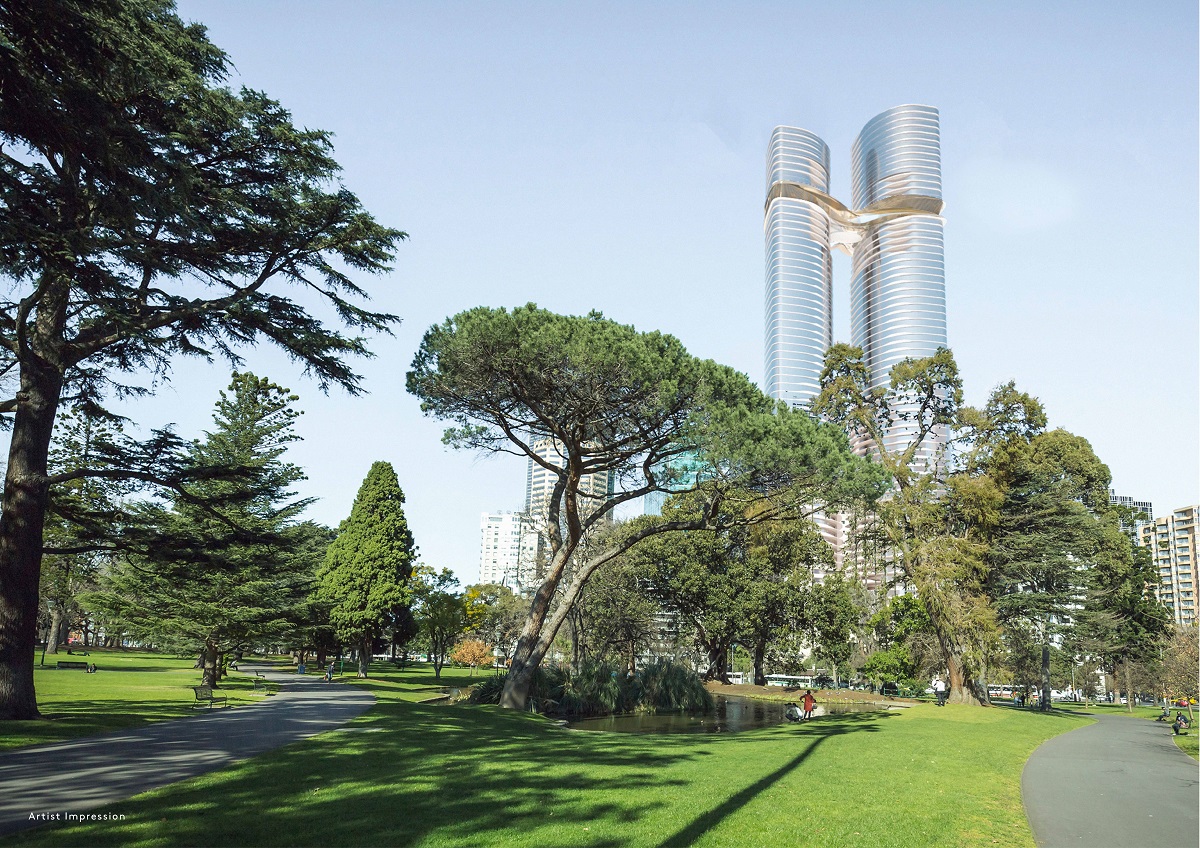 a park with trees and a park with tall buildings in the background
