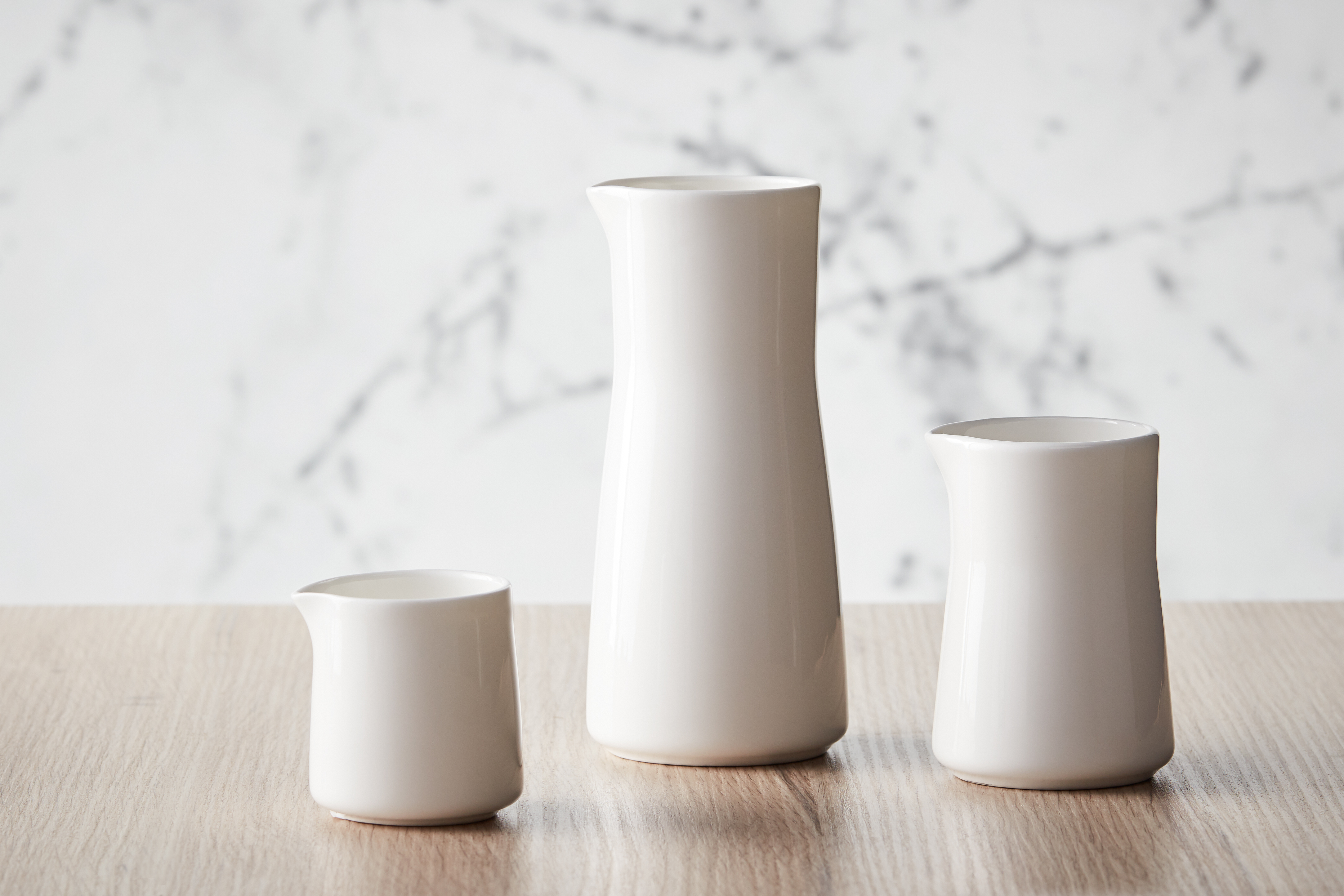 a group of white vases on a table