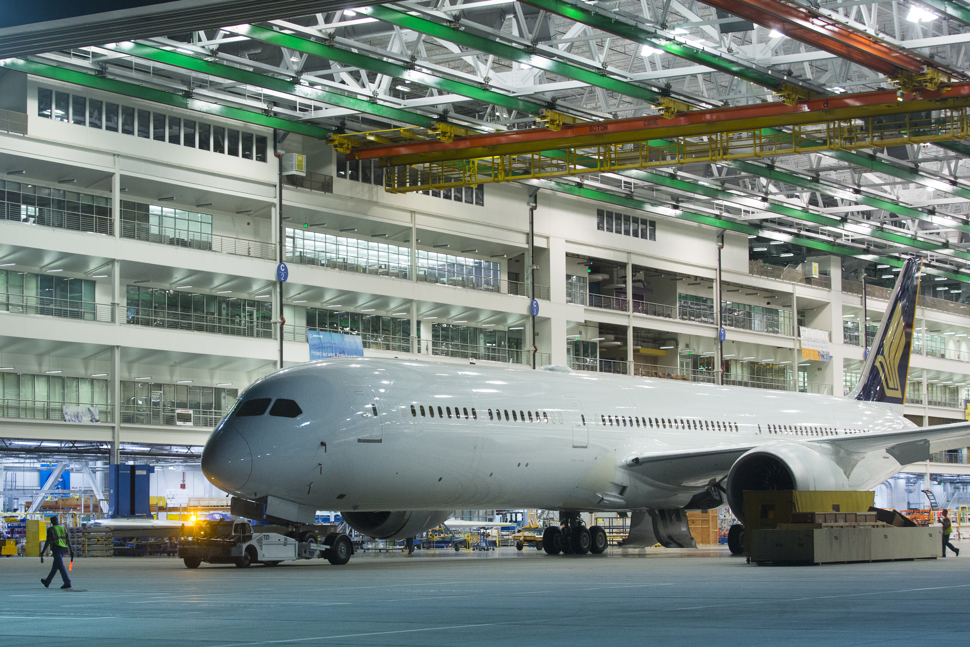 a large white airplane in a hangar