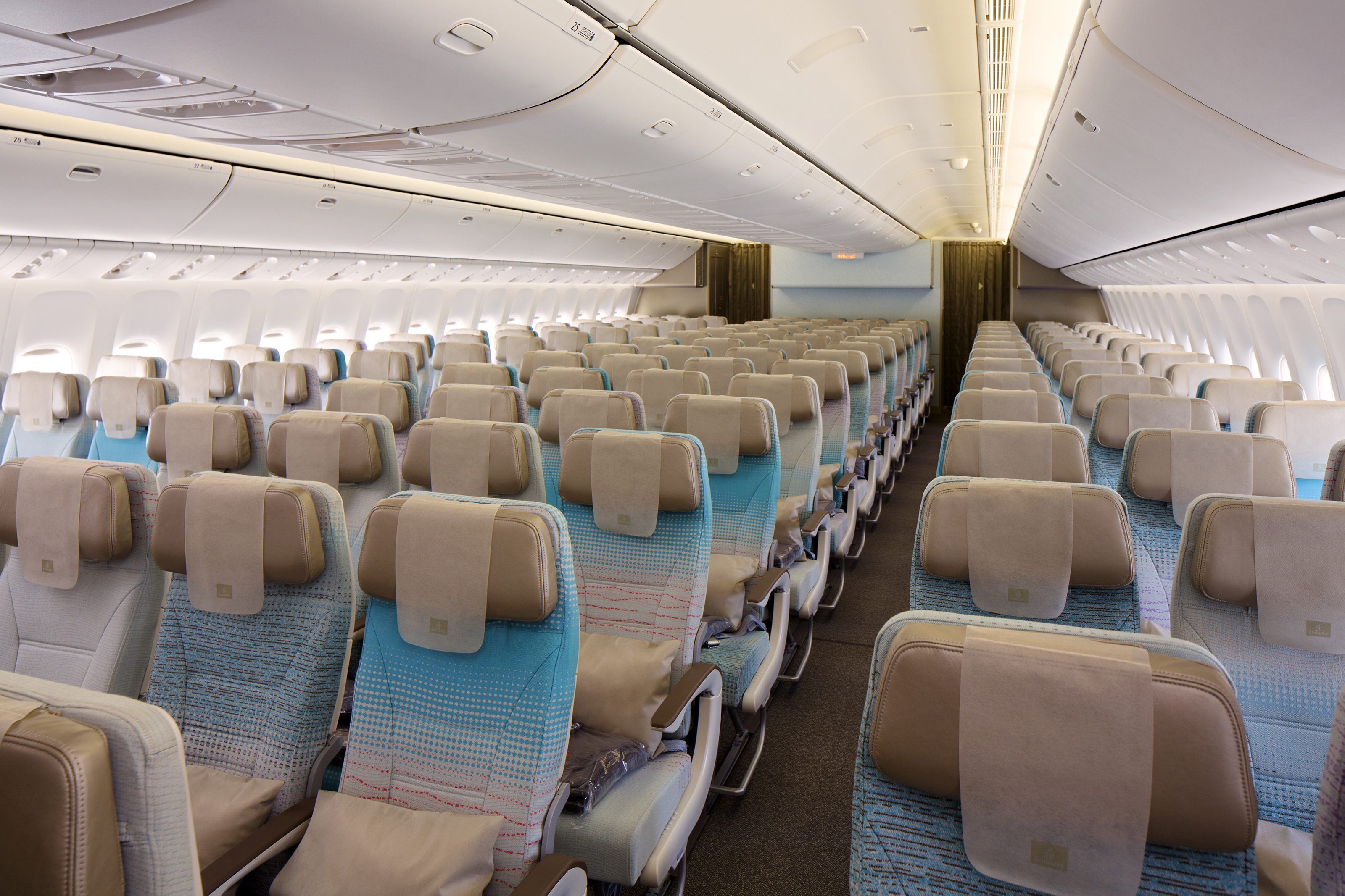 an airplane seats with blue and tan seats
