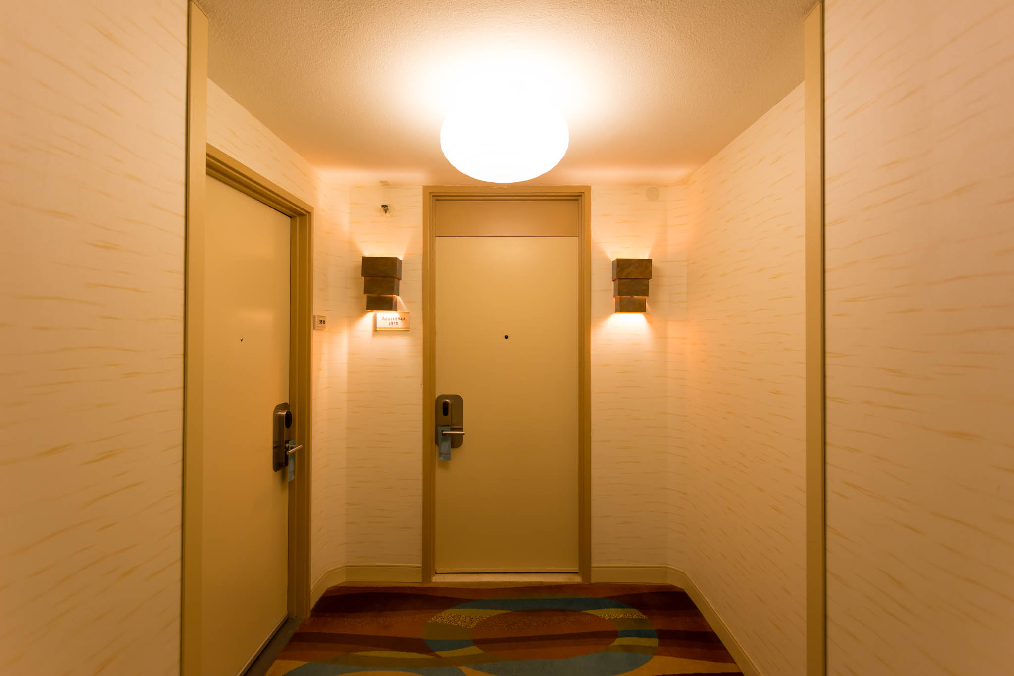 a hallway with two doors and a light