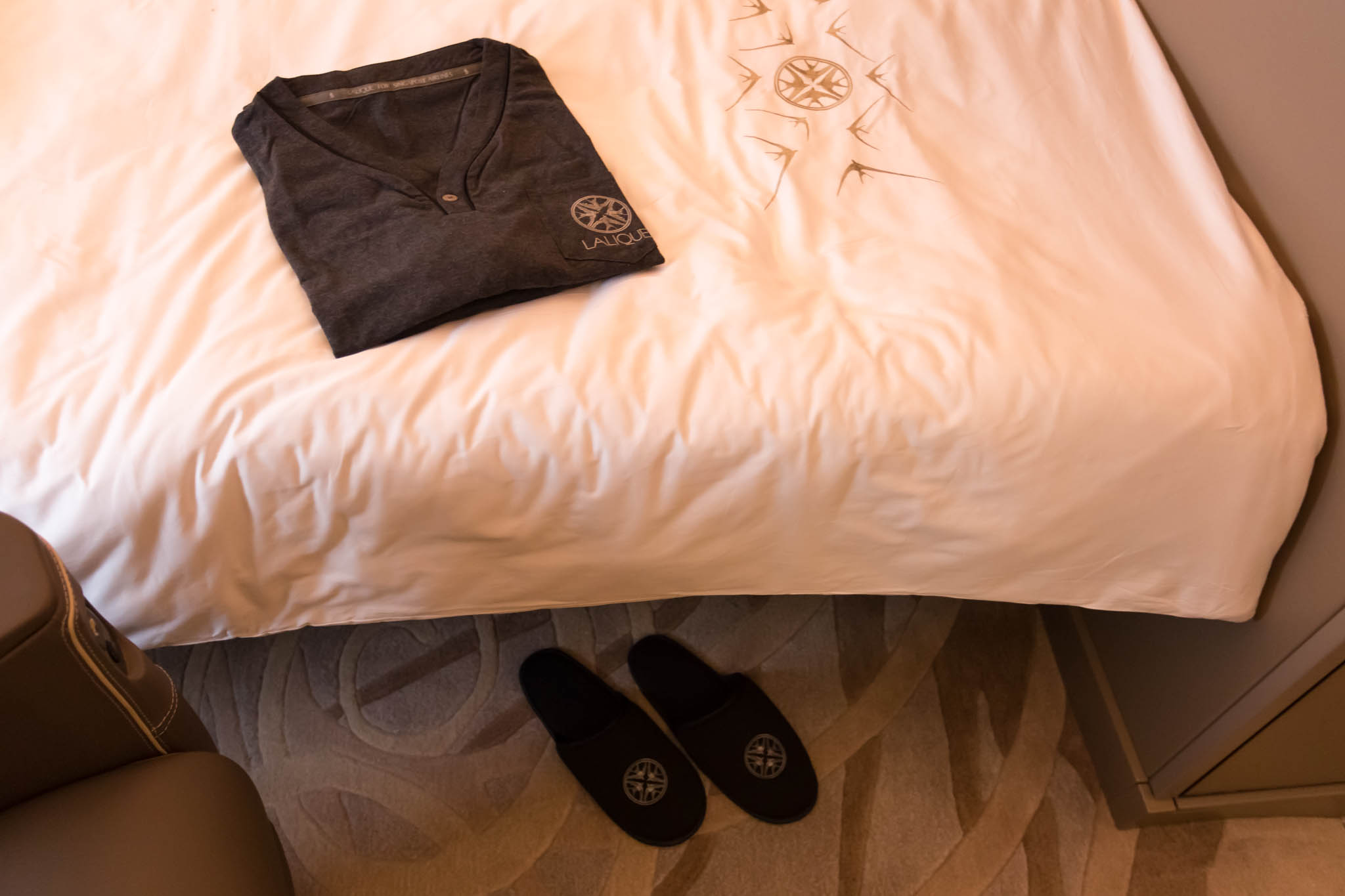 a shirt and slippers on a bed