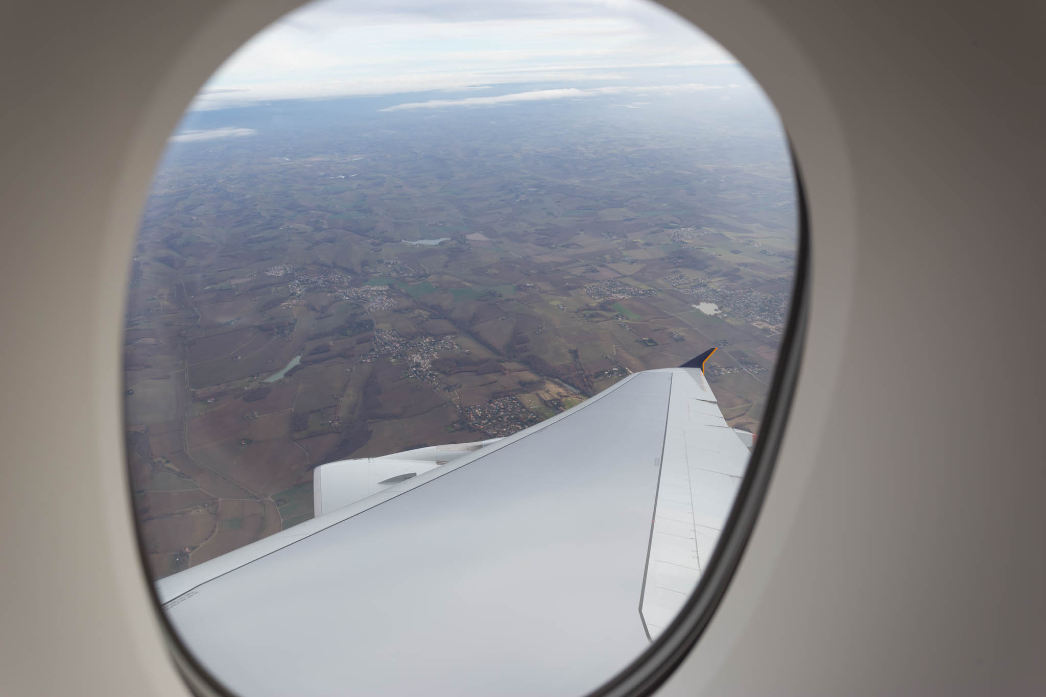 an airplane wing and a view of the earth from a window