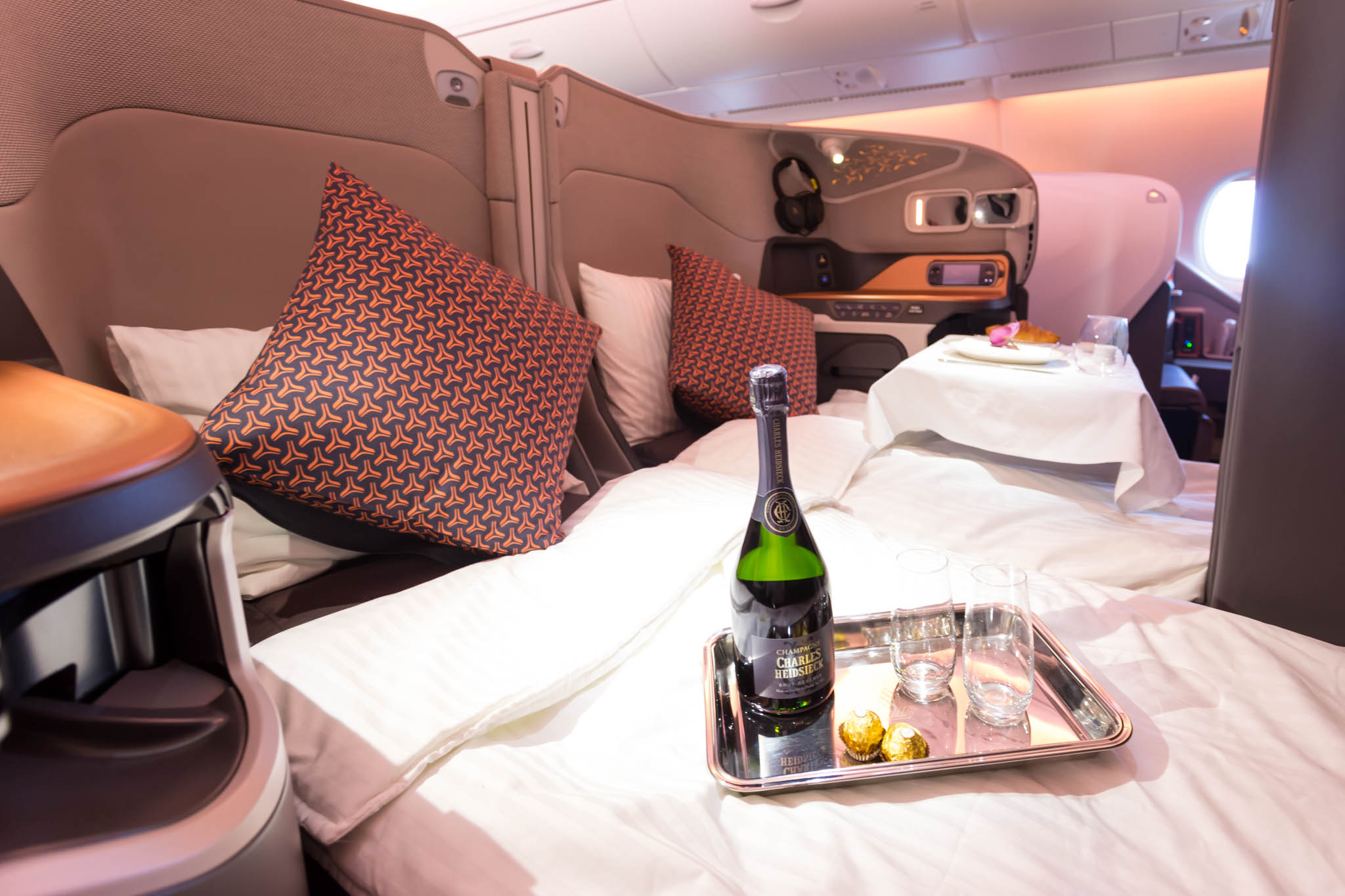 a champagne bottle on a tray in a bed