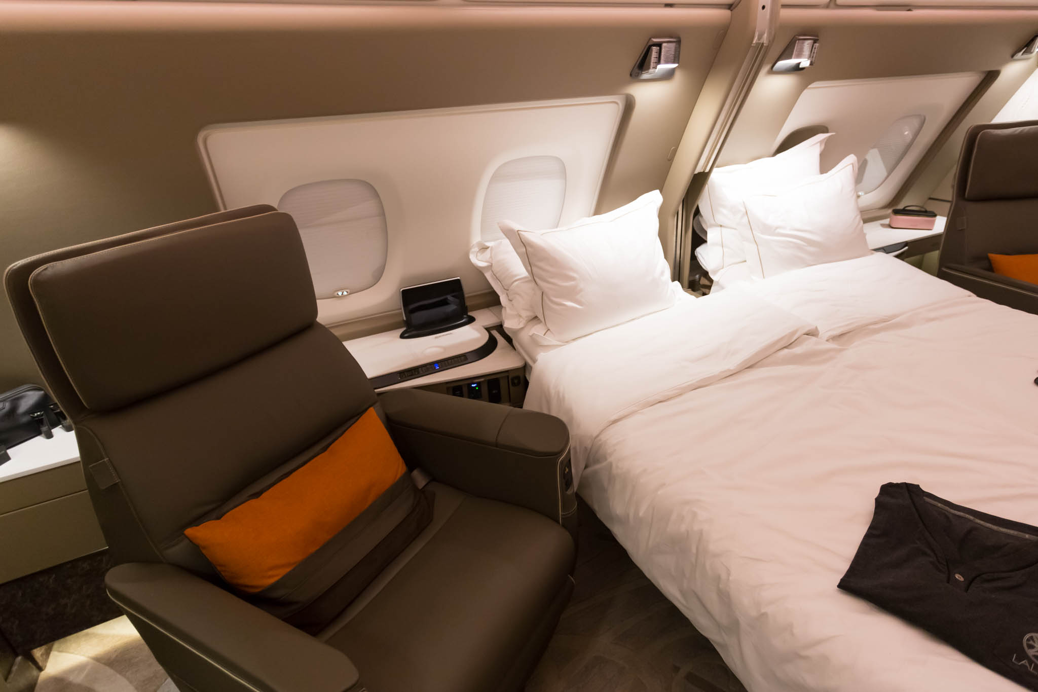 a bed and a chair in a plane