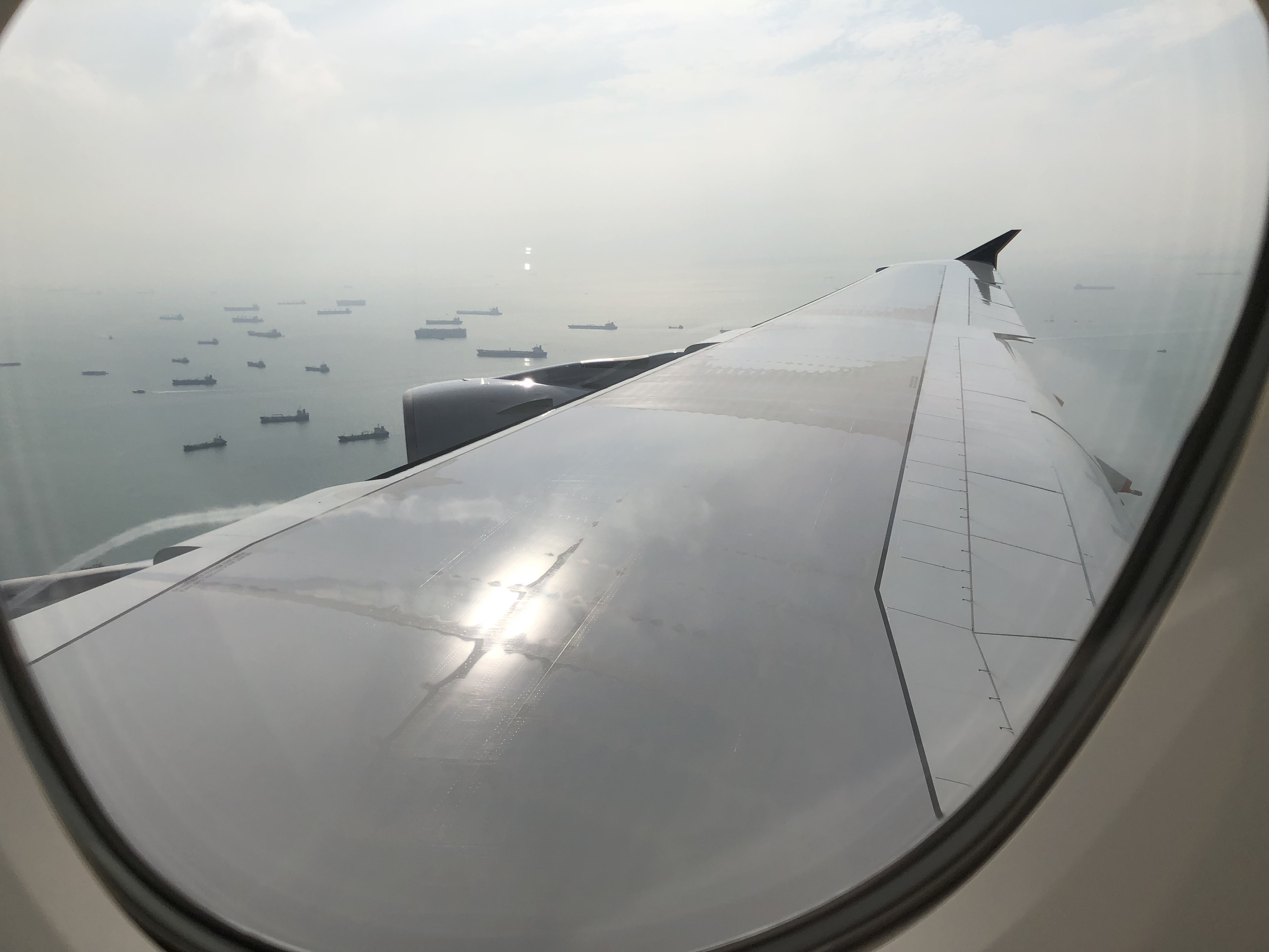 a view of a plane wing and a body of water from a window