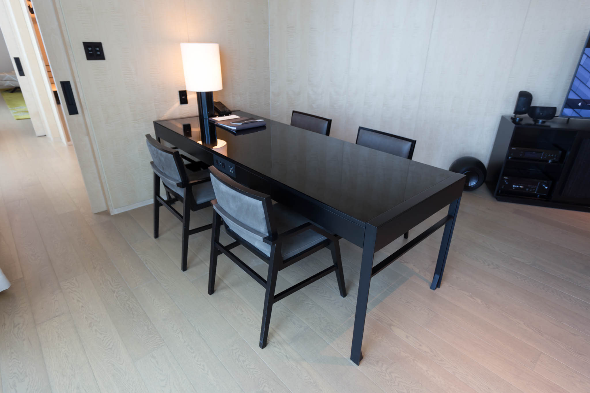 a black table with chairs and a lamp